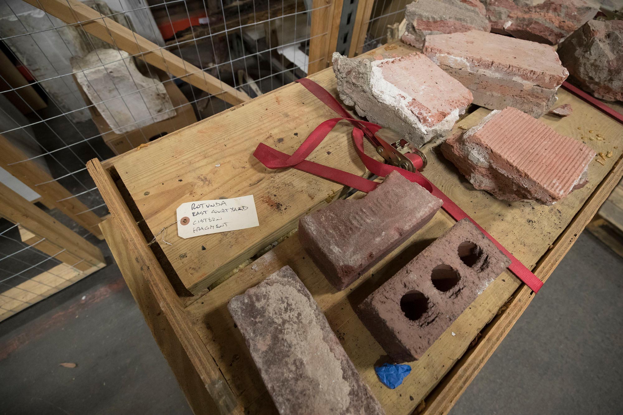 Old bricks sit on a wooden table