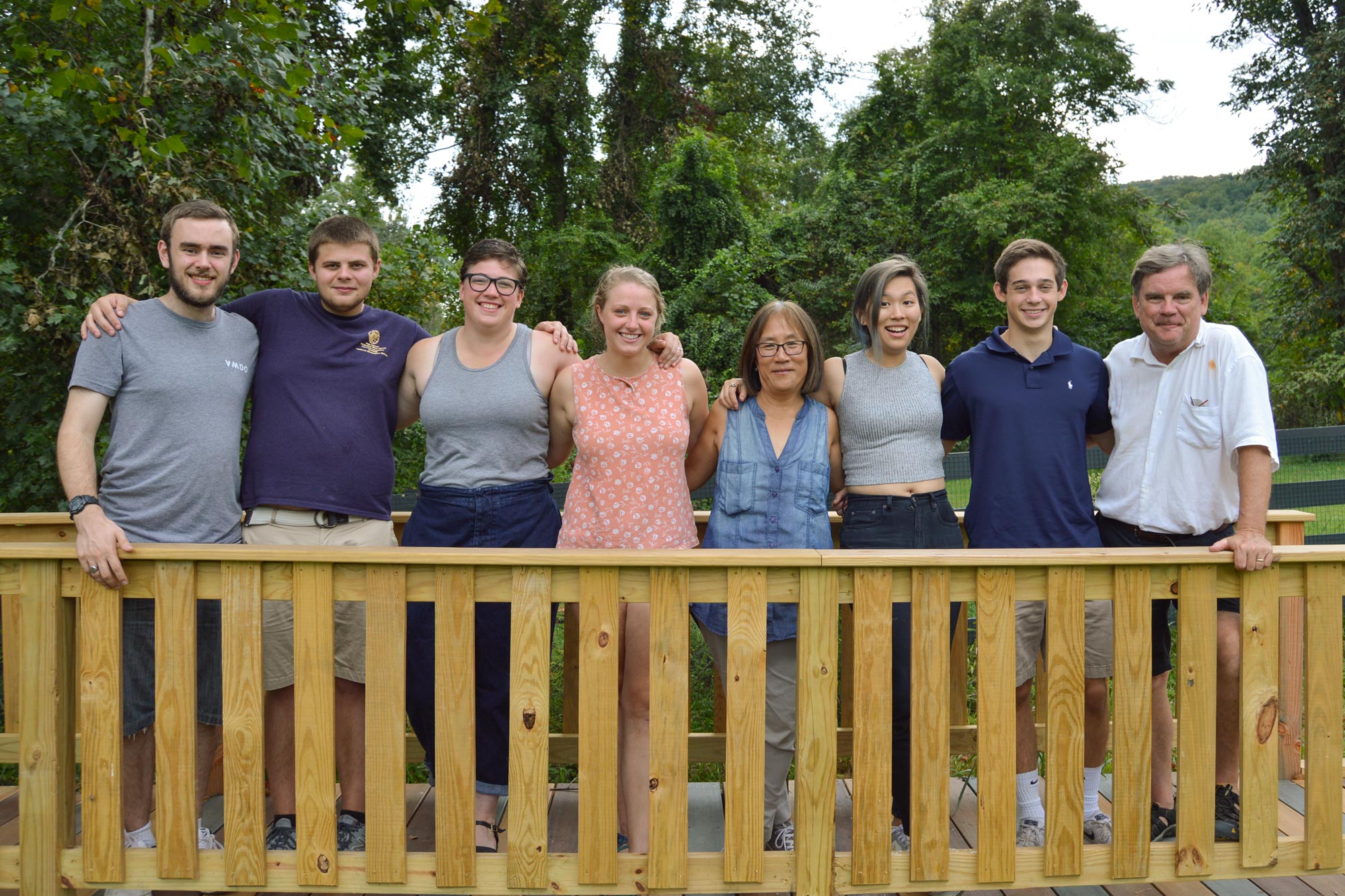 Group stands on a ramp smiling for the camera