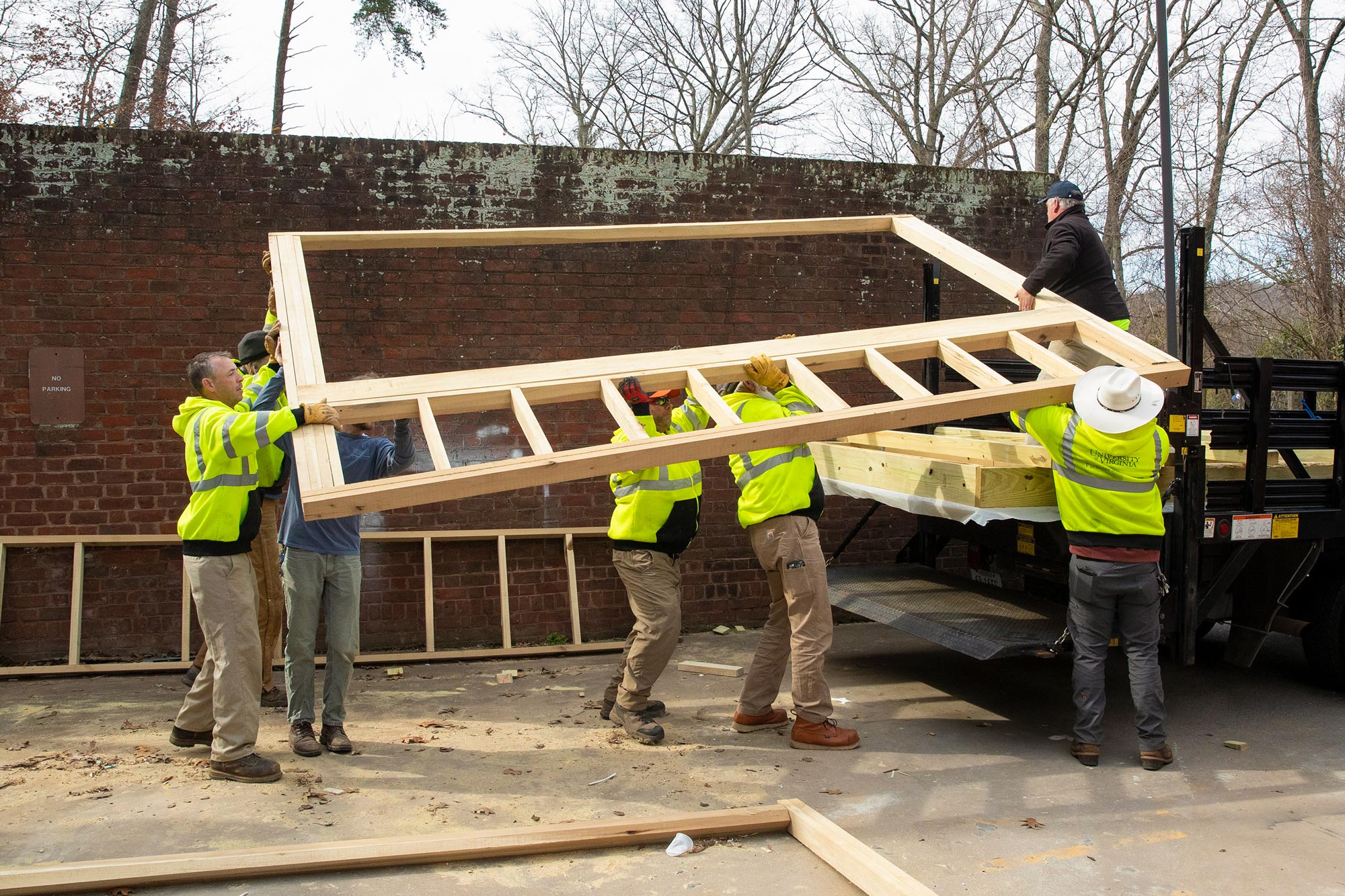 Andrew Spears and Facilities Management workers load assembled sections into a truck together