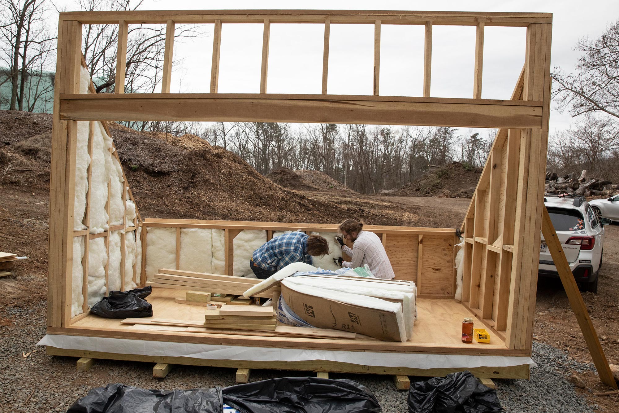 Anson Parker and Andrew Spears putting in insulation into their structure