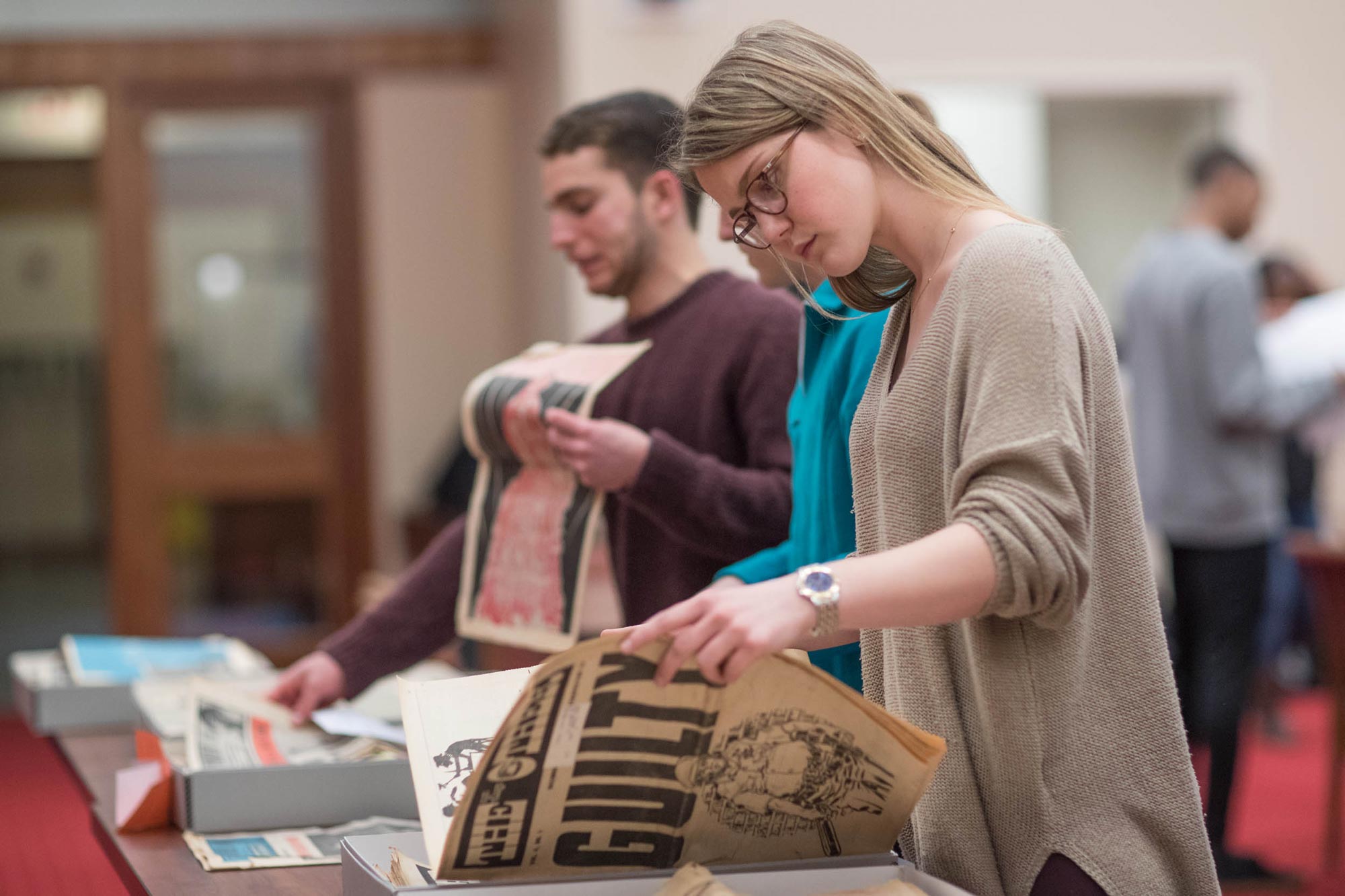 Students look at newspapers from special collections