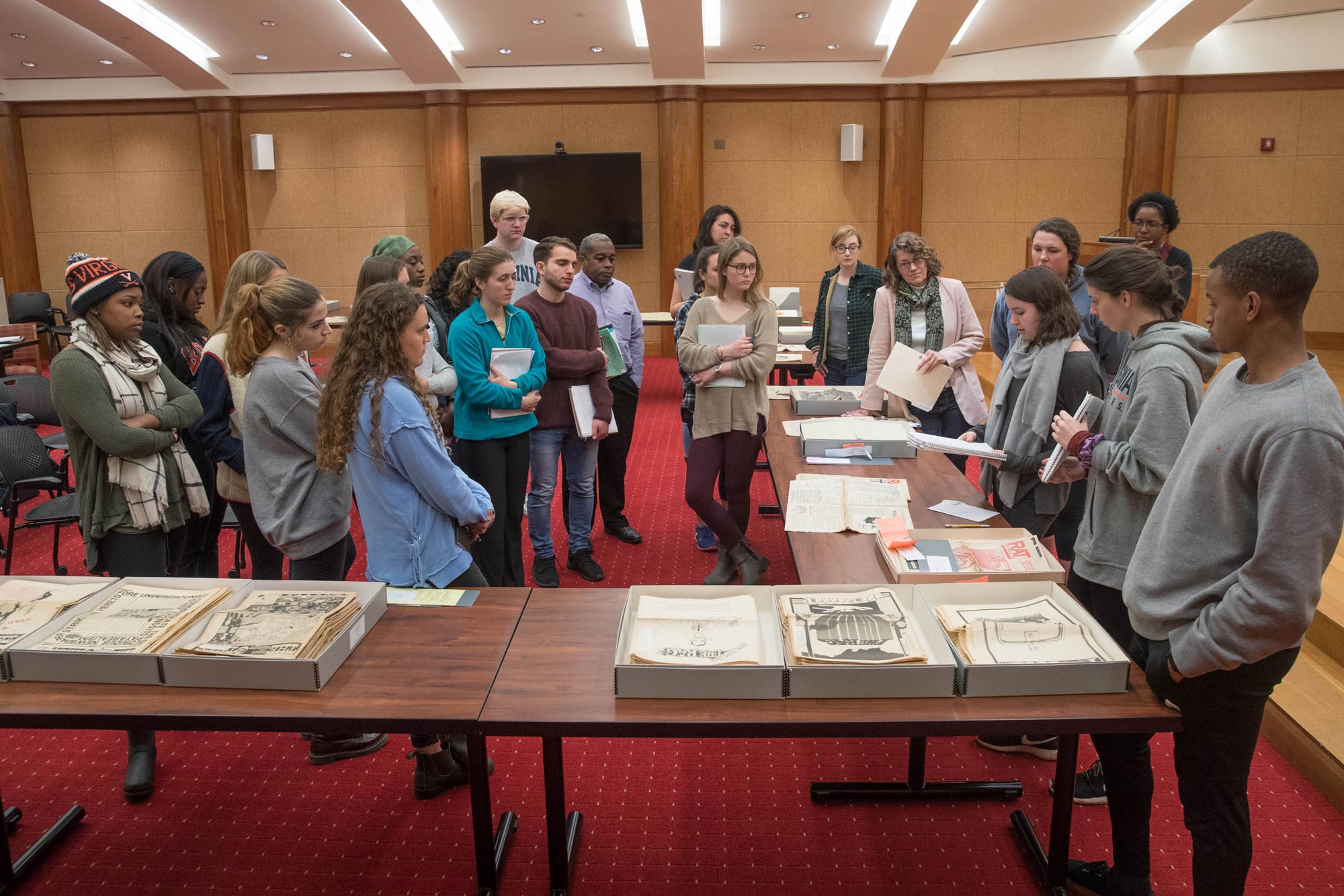 Students look at newspapers from special collections
