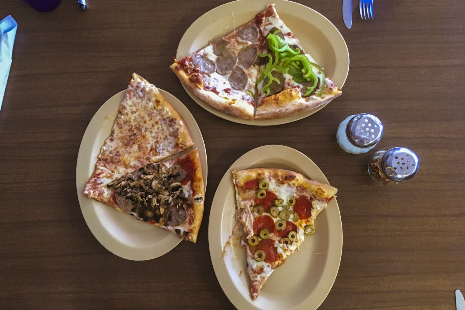 Pizza slices on plastic plates