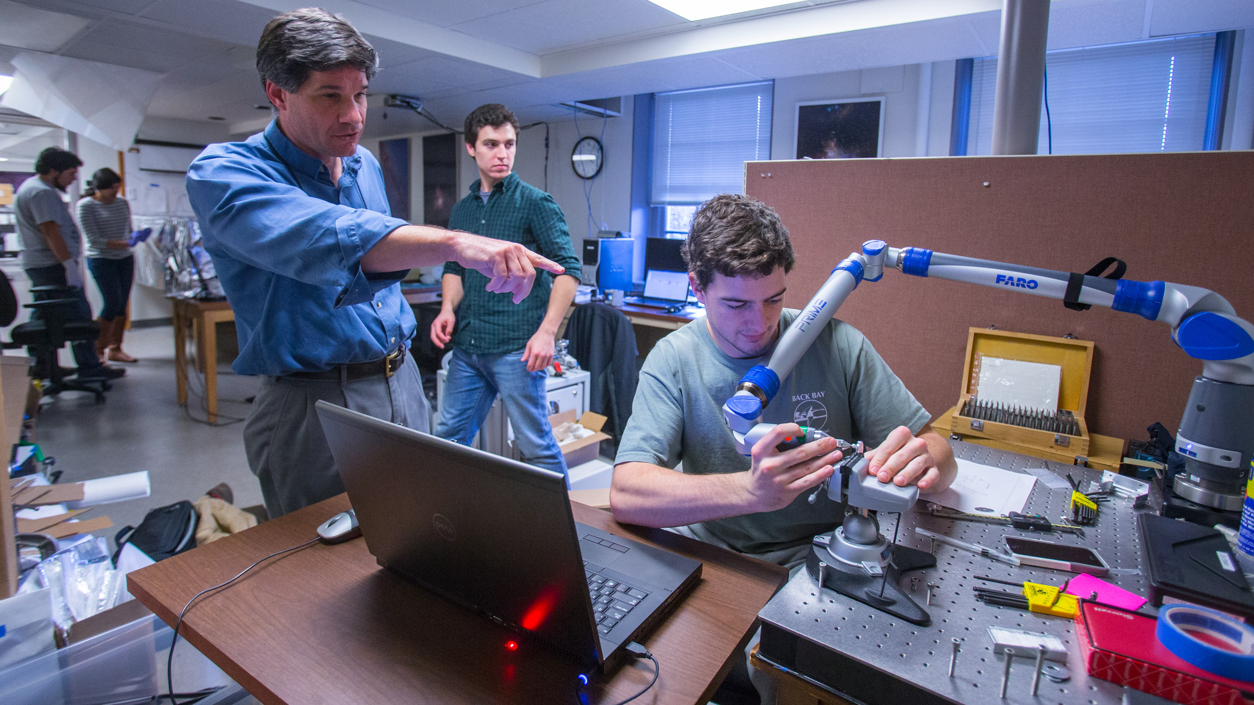 People working with a robot in a lab