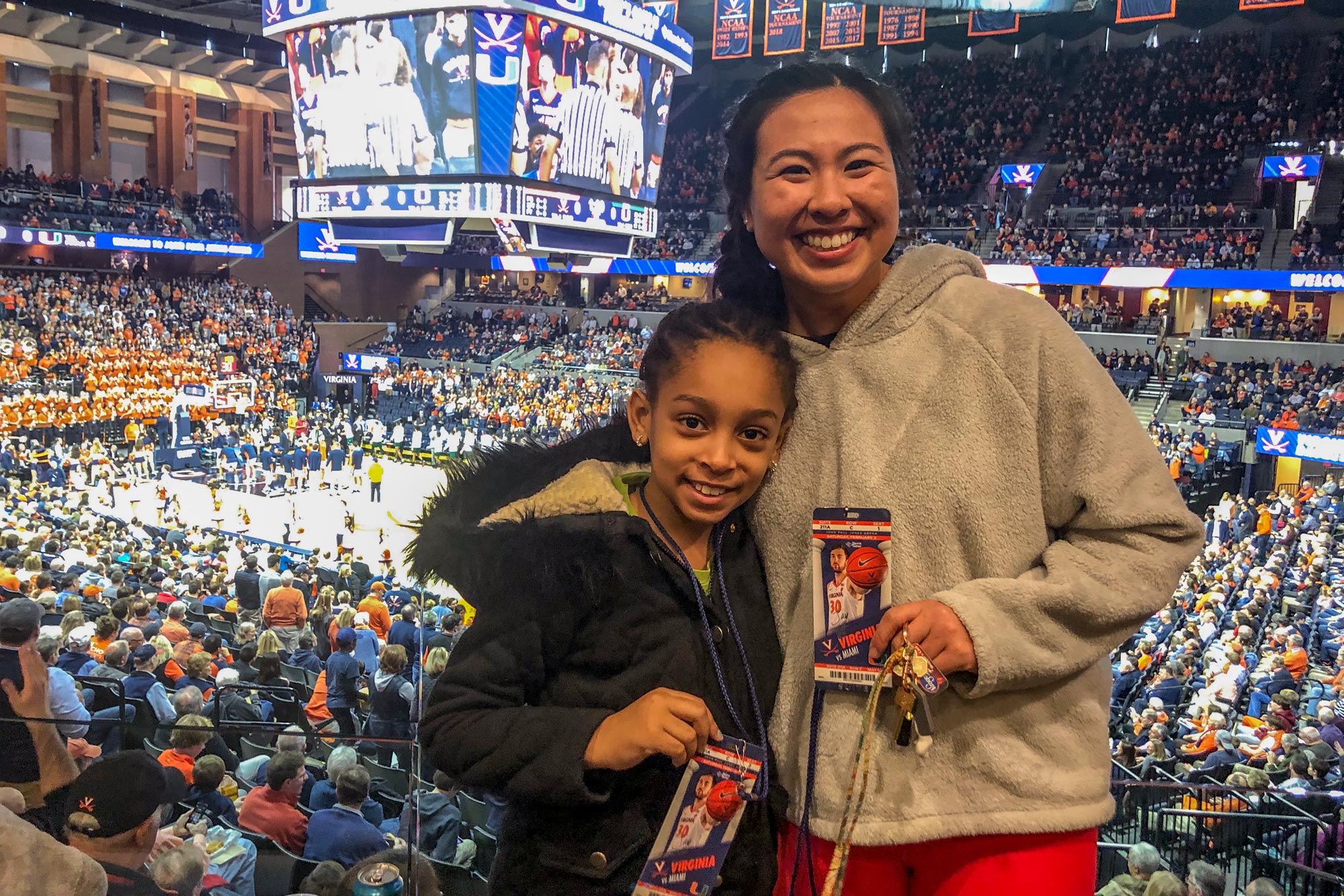 Nazari, right, and  Nia, left, posing together for a picture at a UVA basketball game