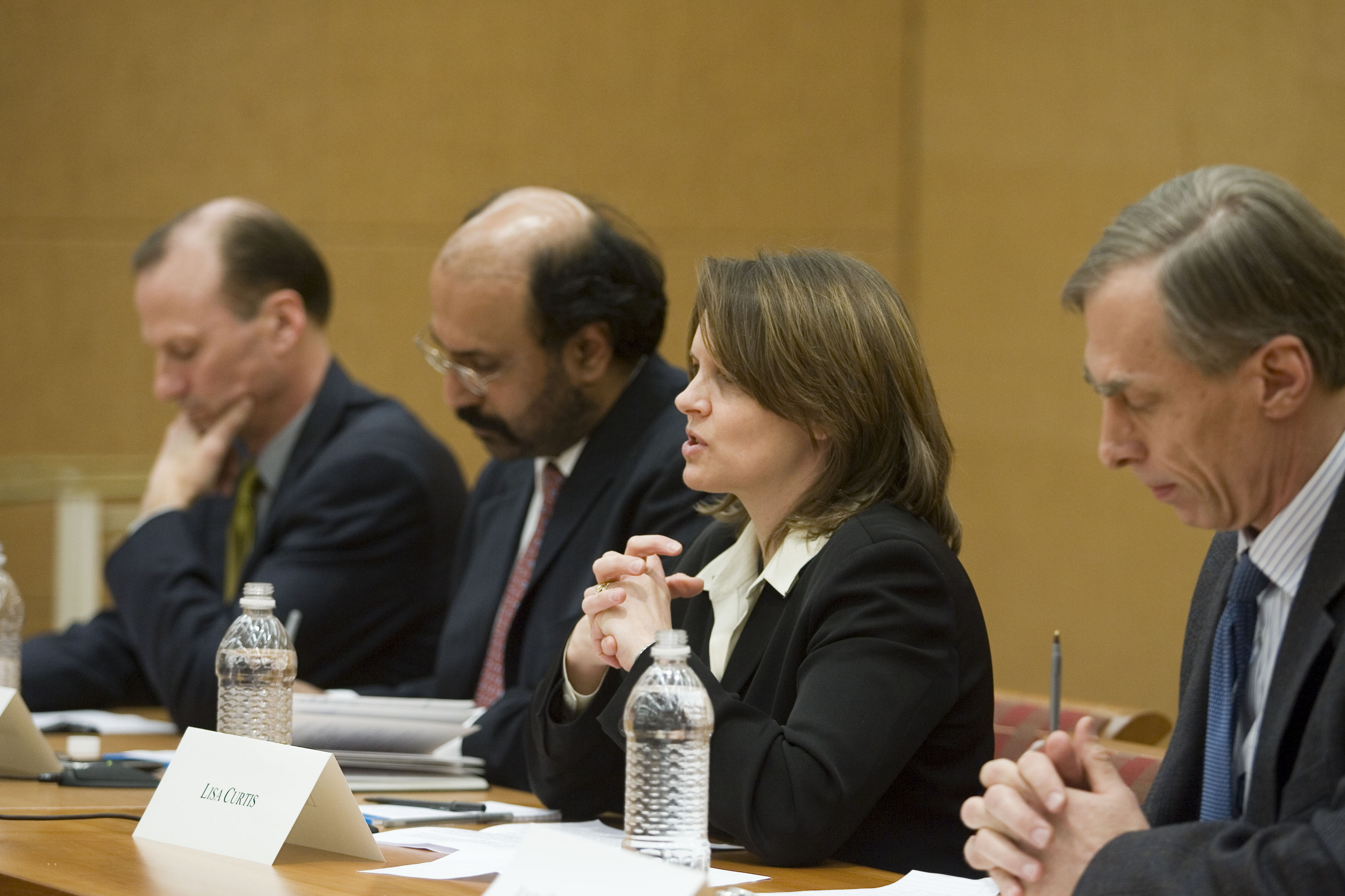 Jeff Legro, Hassan Abbas, Lisa Curtis, John Echeverri-Gent sit at a table during a panel discussion