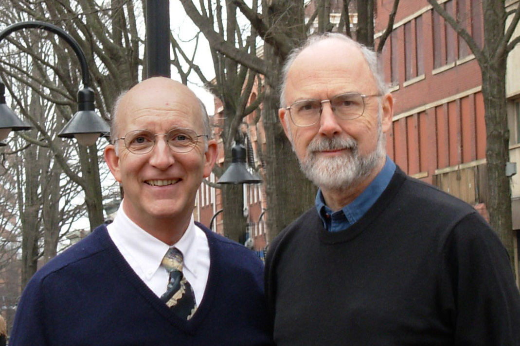 David Phillips, left, and William Lucy, right, stand together smiling at the camera