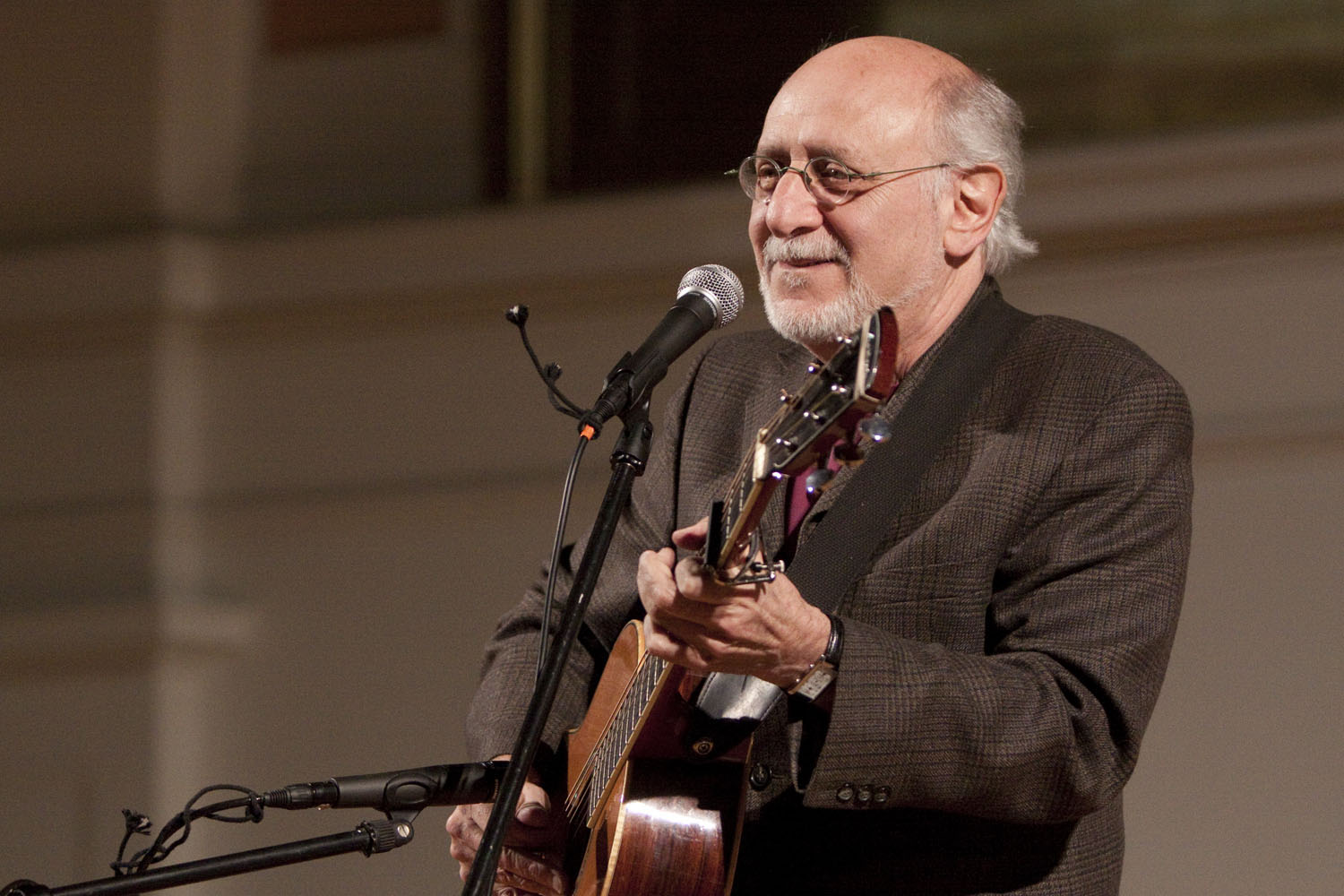 Peter Yarrow singing and playing guitar on stage