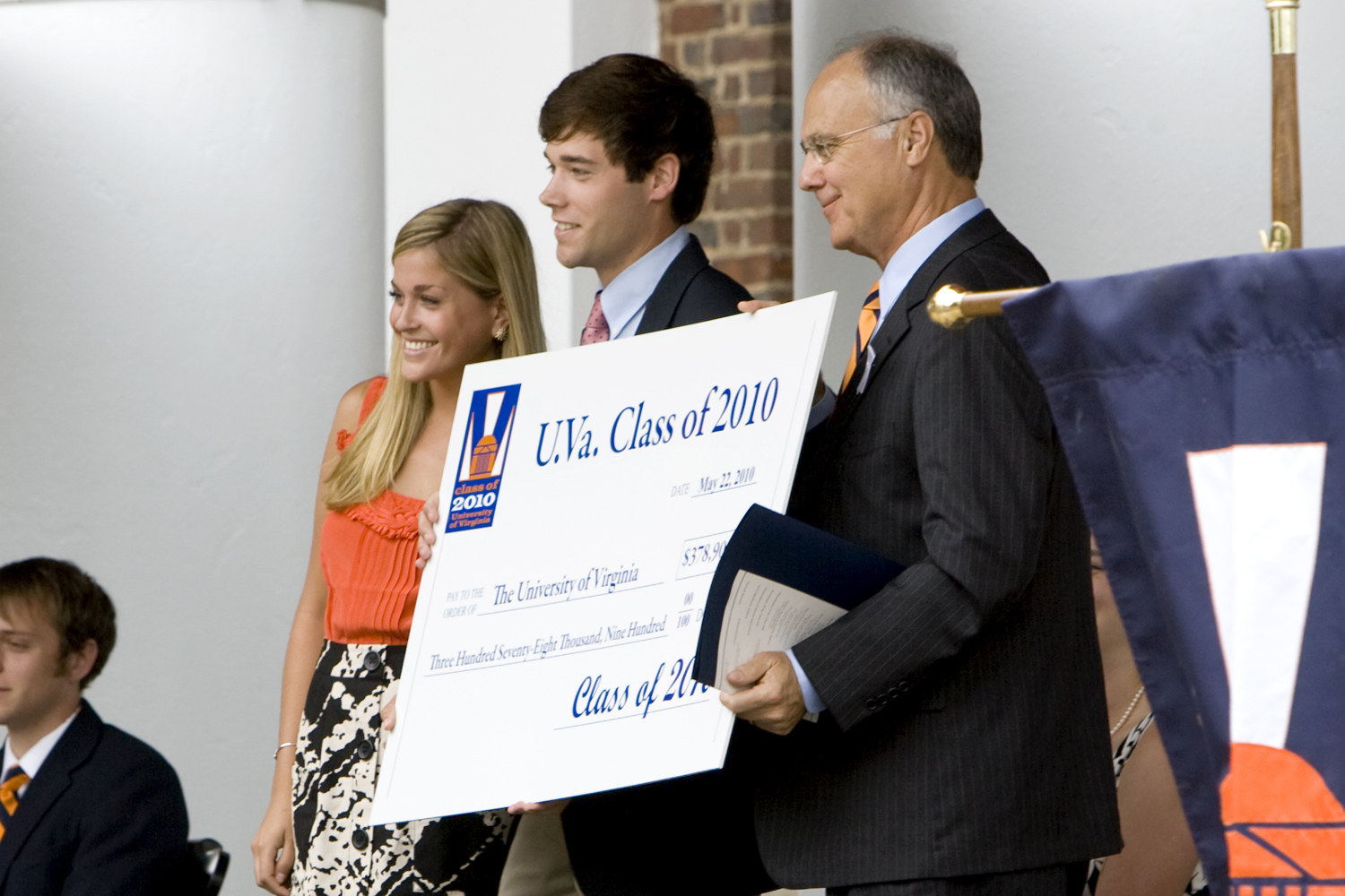 Matt Schrimper, middle, Katie Peabody, left, give  President John T. Casteen III, right, a check from teh class of 2010 