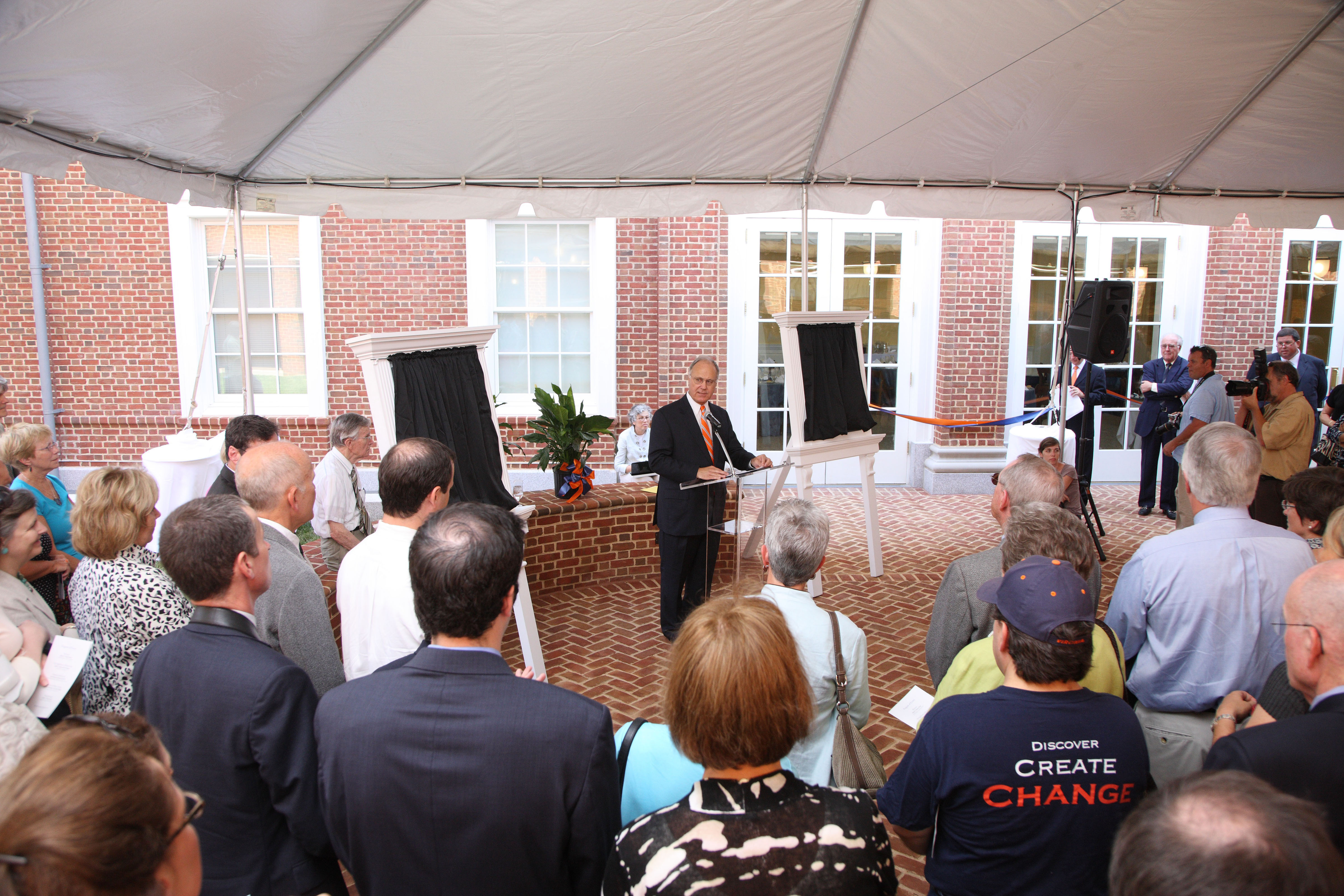 Man speaking to a crowd of people at the Bavaro Hall dedication