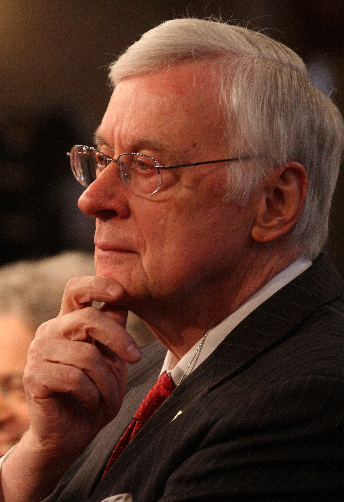 Gerald Baliles listening while touching his chin with his hand