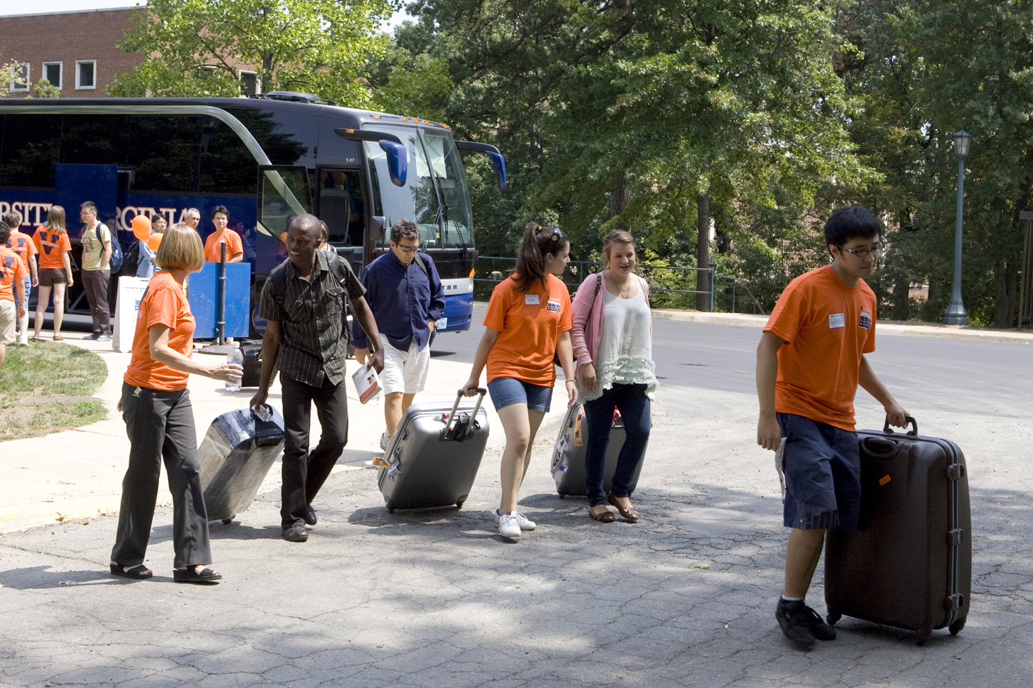 Students moving personal belongings into a dorm