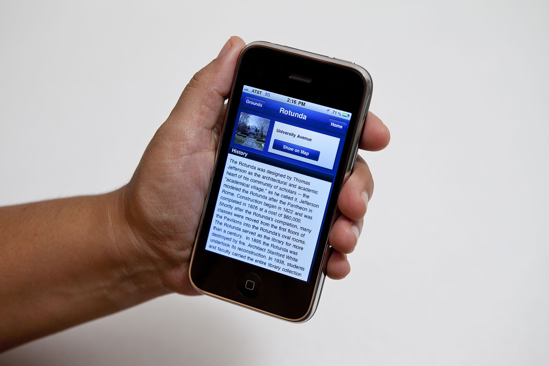 Person holding an iPhone with the UVA iPhone app open and information about the Rotunda on the screen