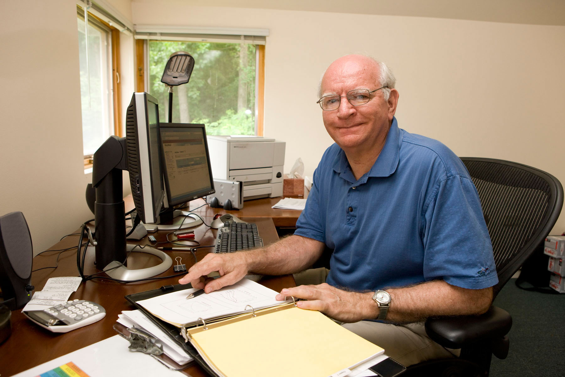 Timothy Salthouse sitting at a desk smiling at the camera