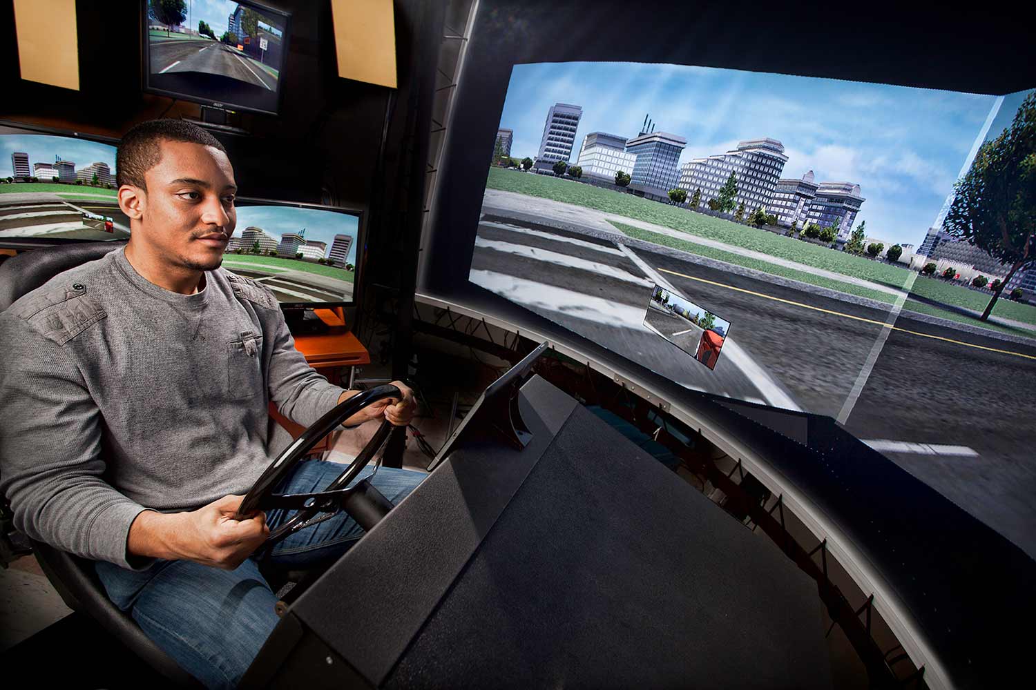 Student driving a simulated car
