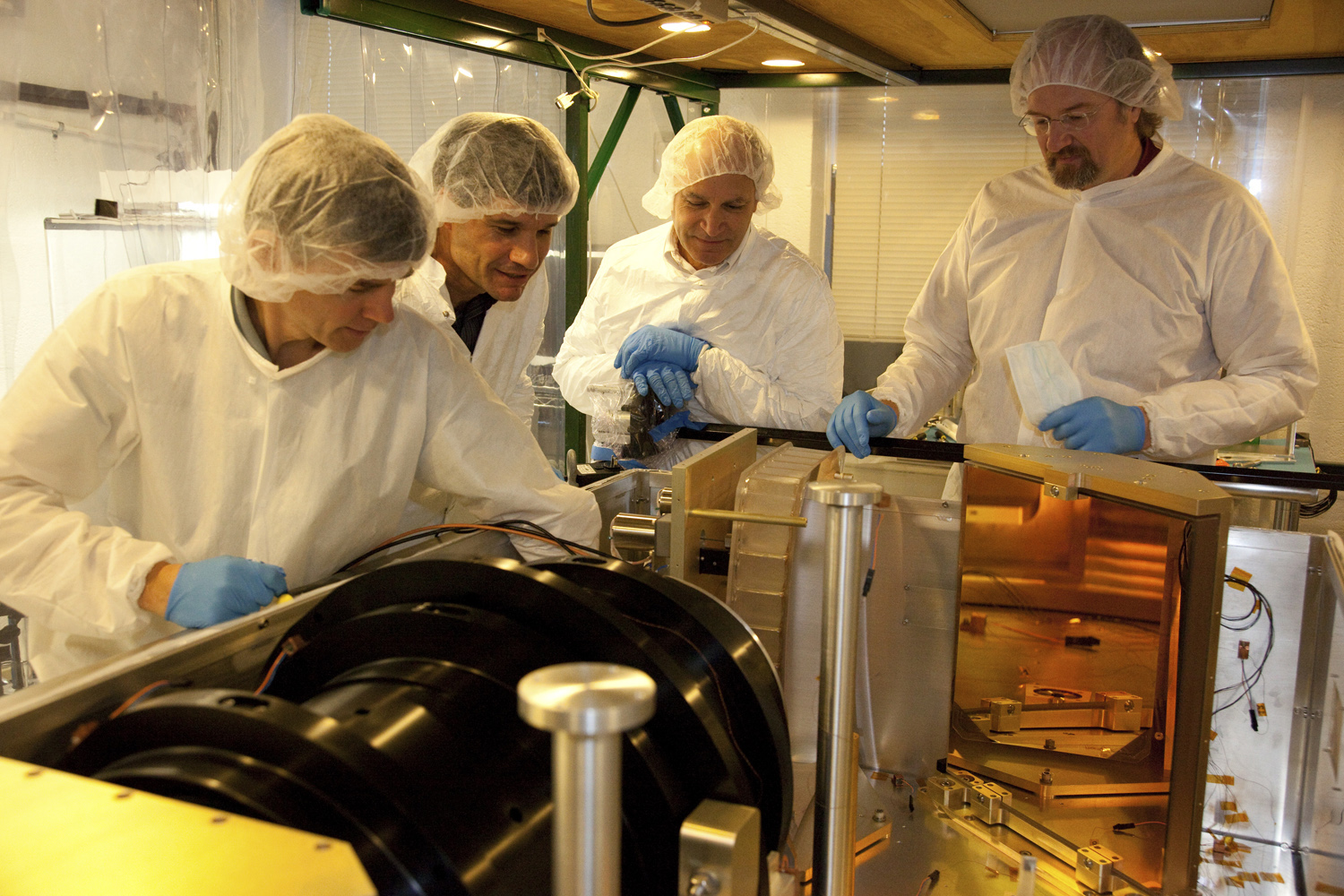 Left to right: Mike Skrutskie, John Wilson, Fred Hearty and Steven Majewski examine the high-resolution, infrared-sensitive spectrograph