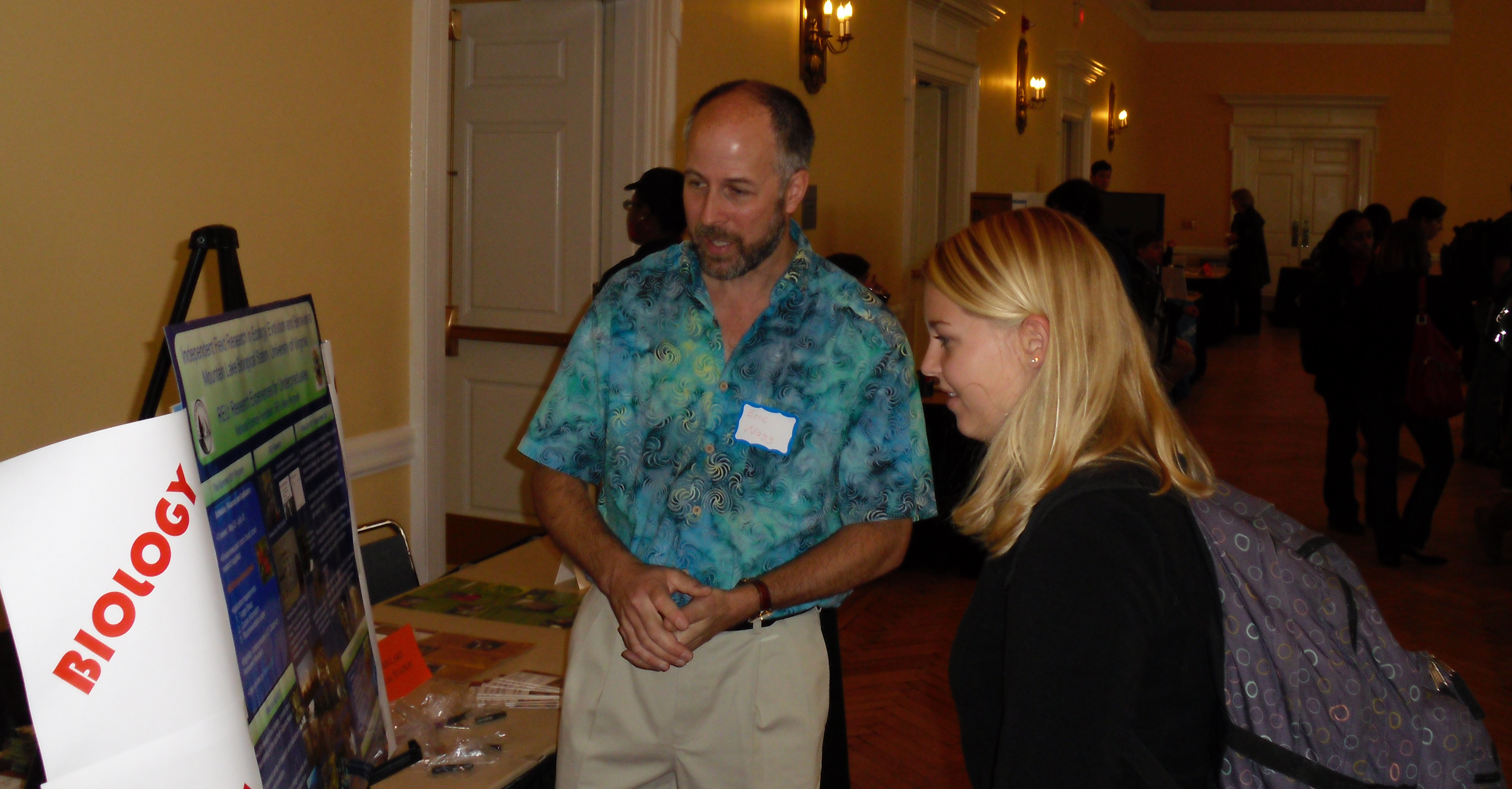 Eric S. Nagy (left) talks to Morgan Wagner, right about his booth