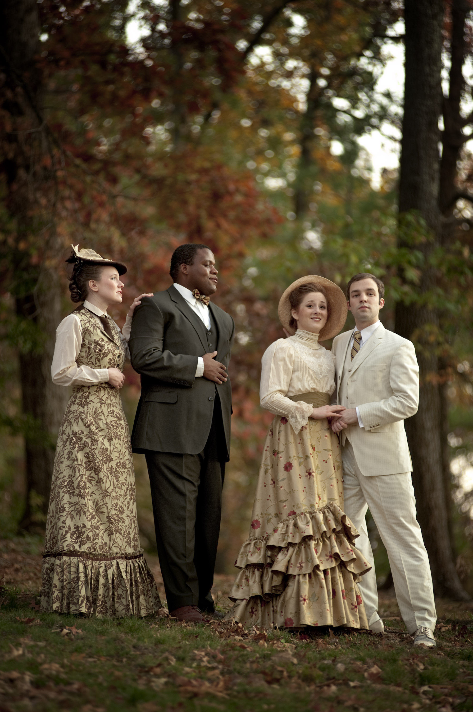 Cast from a play dressed in 1800 period clothing stand outside