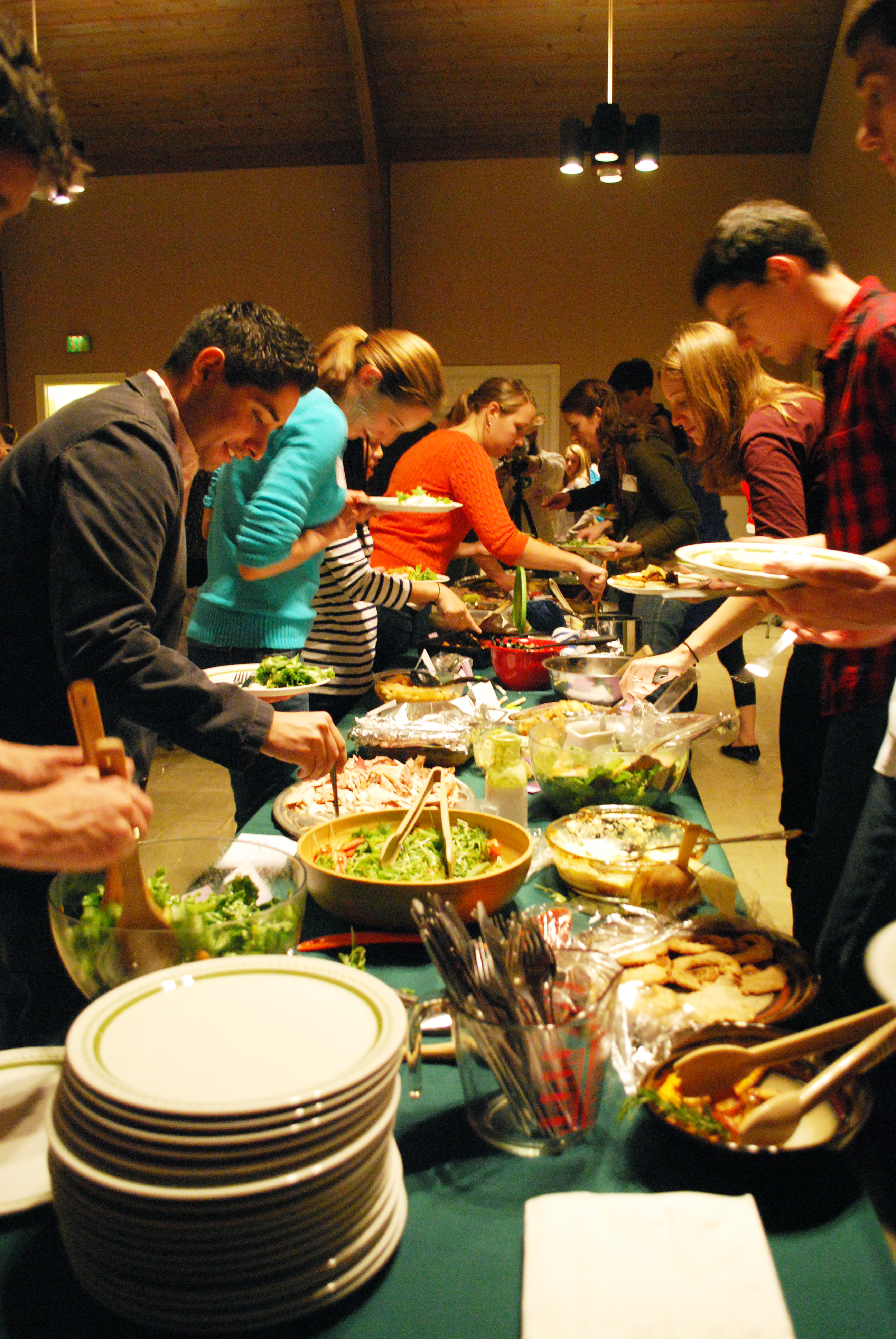 Group of people getting food from a buffet line