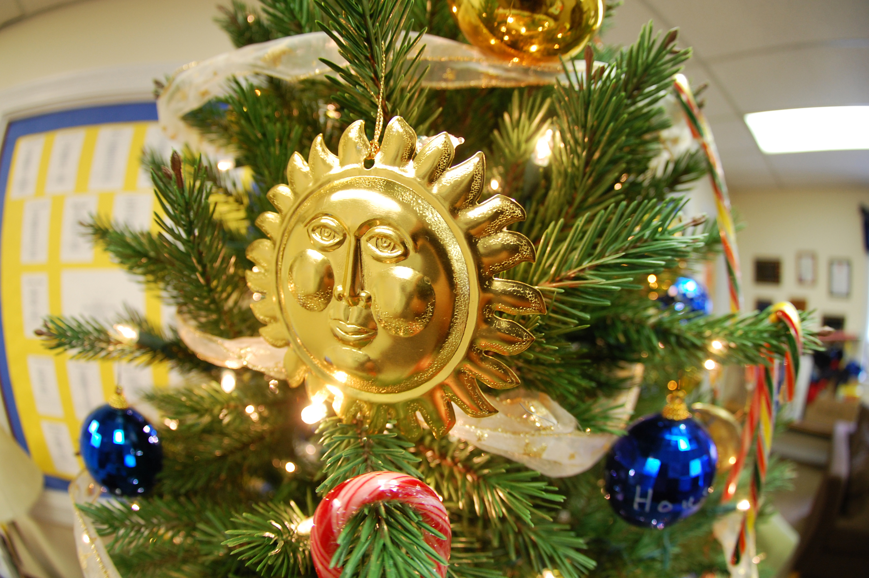 Sun Christmas ornament on a Christmas tree