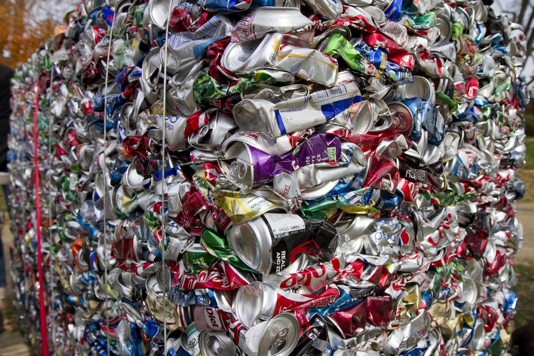 Thousands of crushed aluminum cans tied up in cubes from a UVA game day