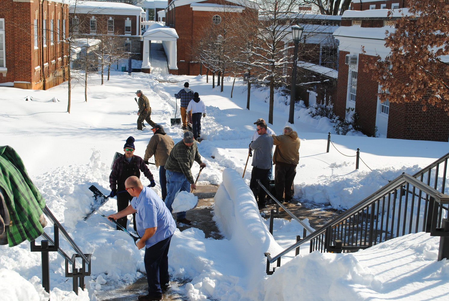 Facilities Management workers clearning the sidewalks from snow