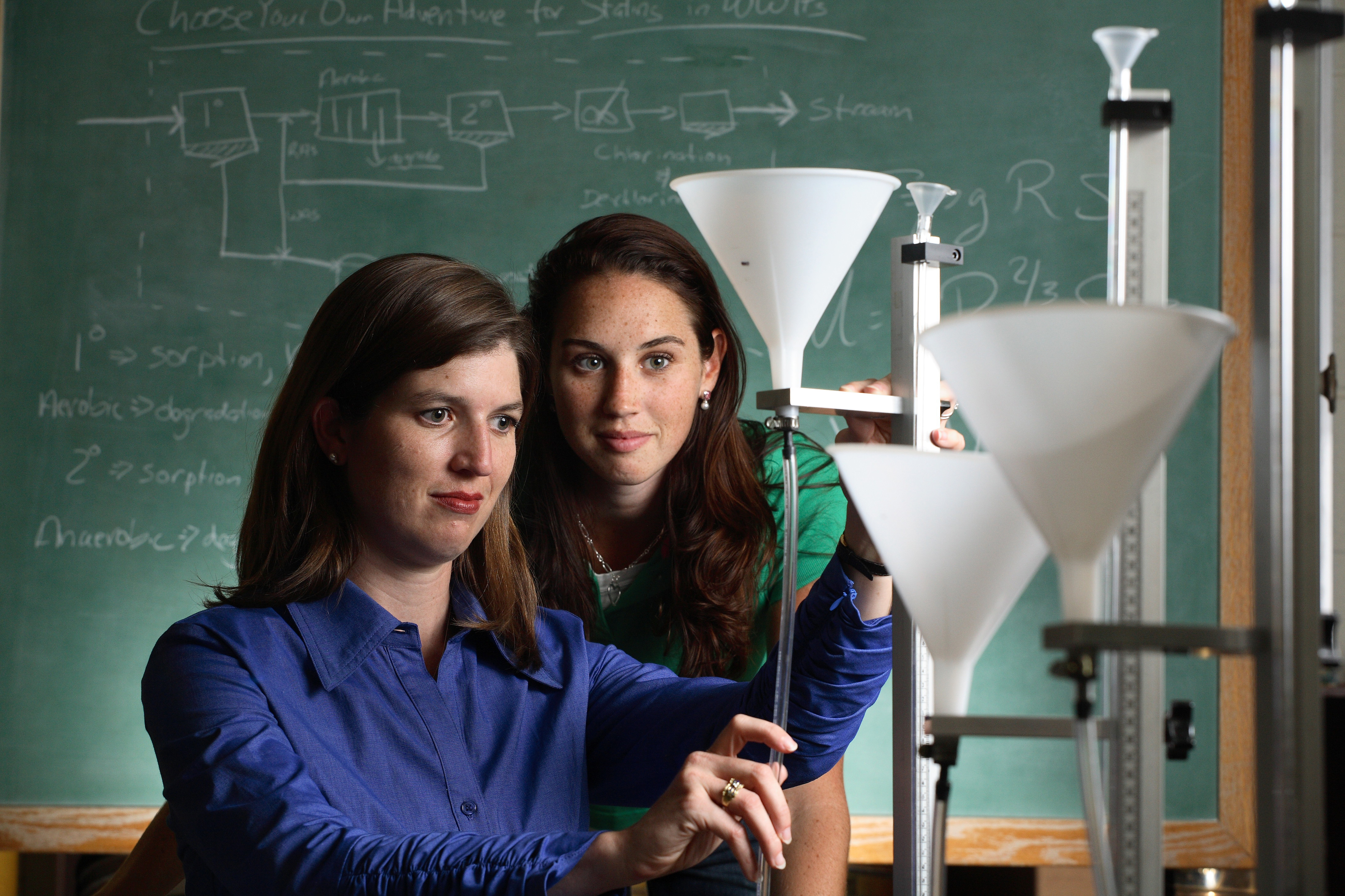 Joanna Curran works with another woman on a science experiment 