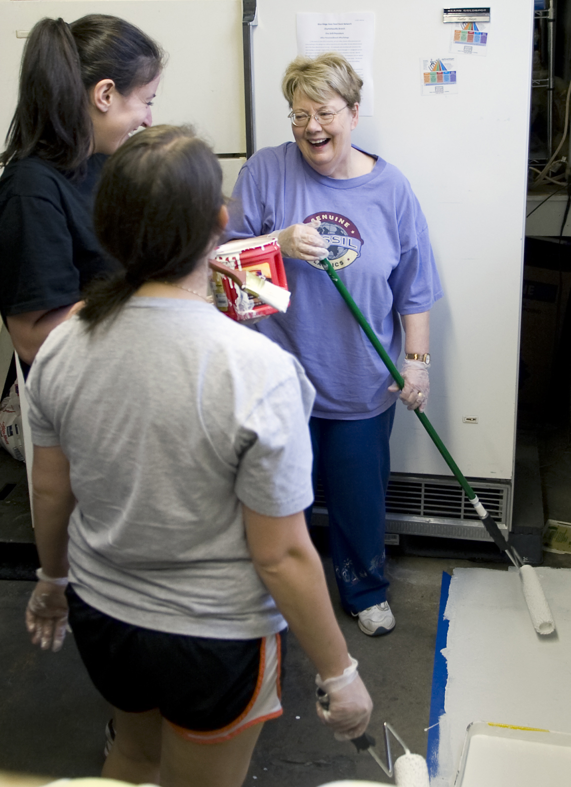 President Sullivan talking to two women while they take a break from painting