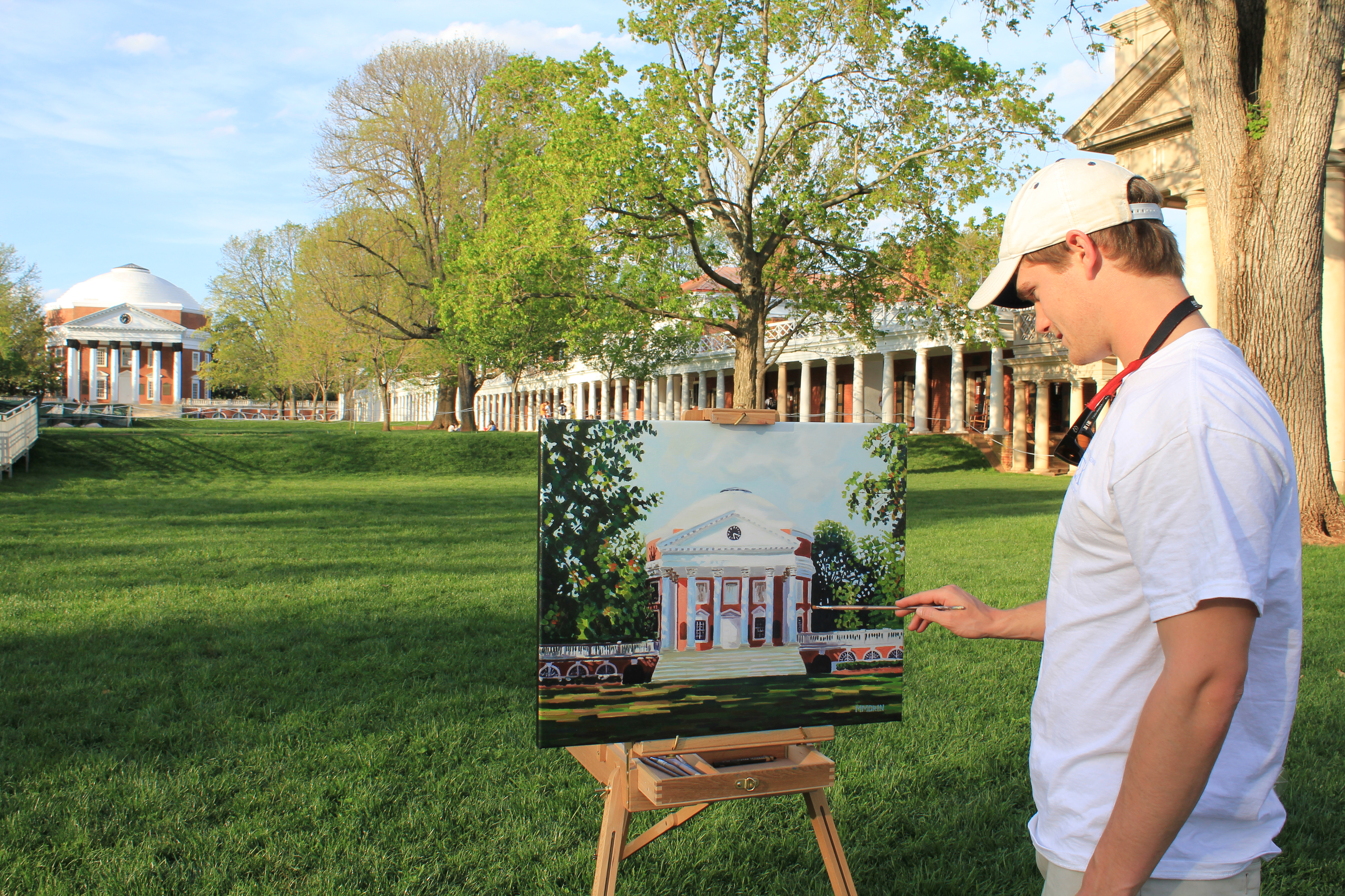 Miles Morin painting the Rotunda on a canvas
