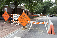 Construction signs blocking the road telling drivers of a new traffic pattern ahead