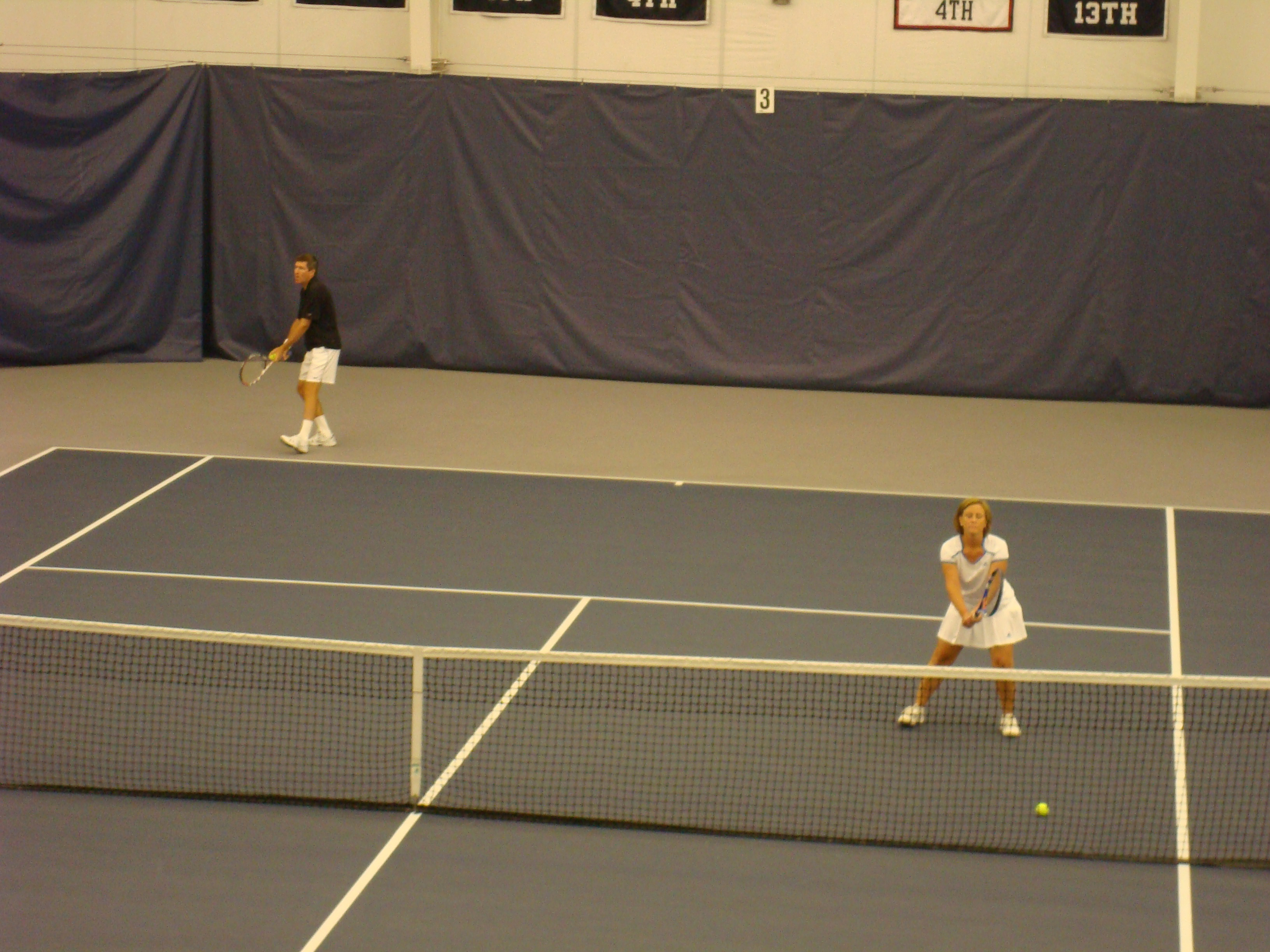 Mike Cline and Donna Cox playing Tennis on a court