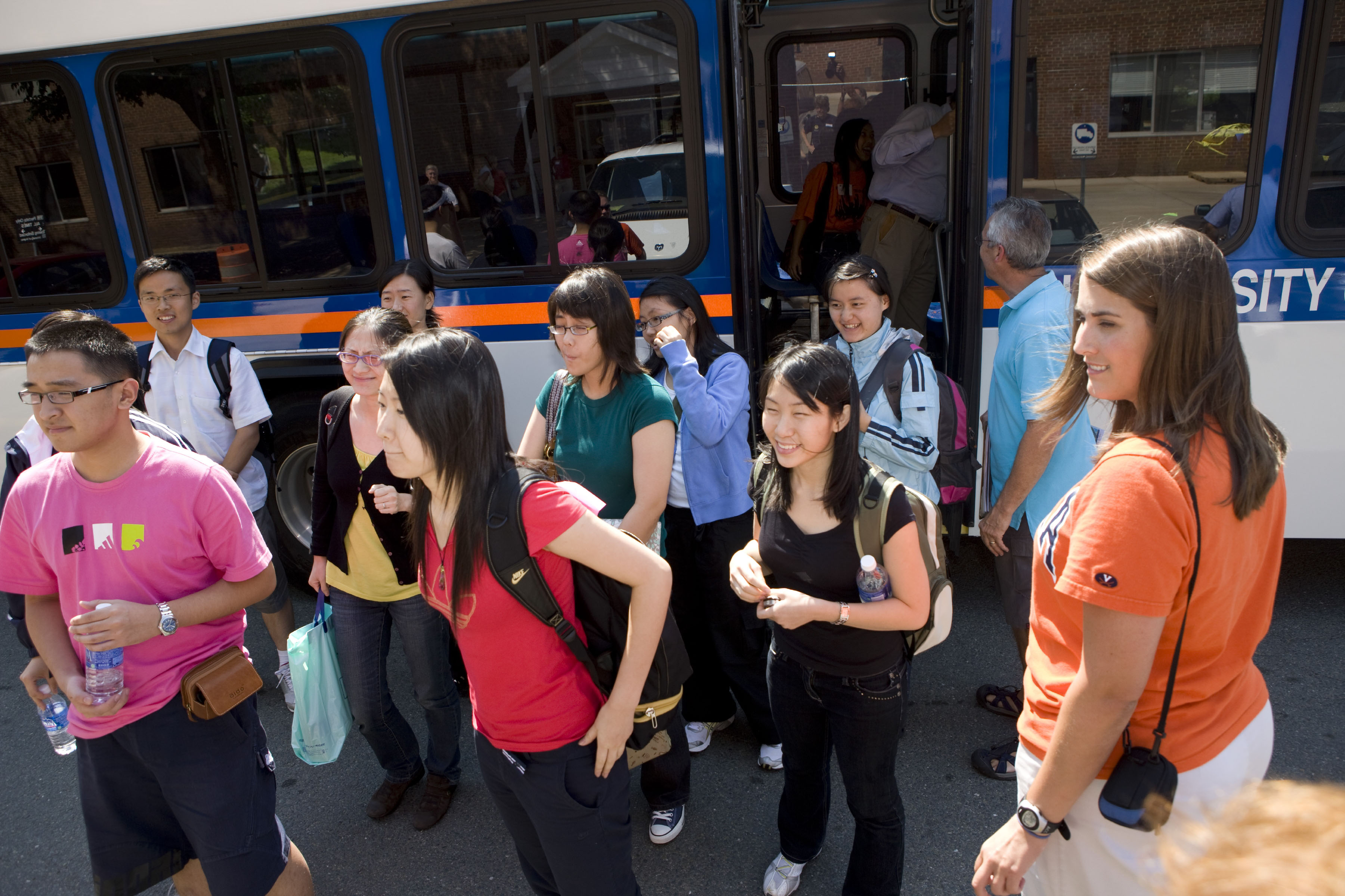 Students getting off of a public transportation bus