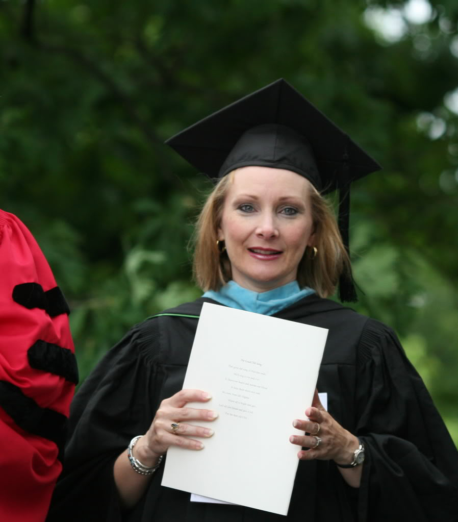 Graduate holding her diploma