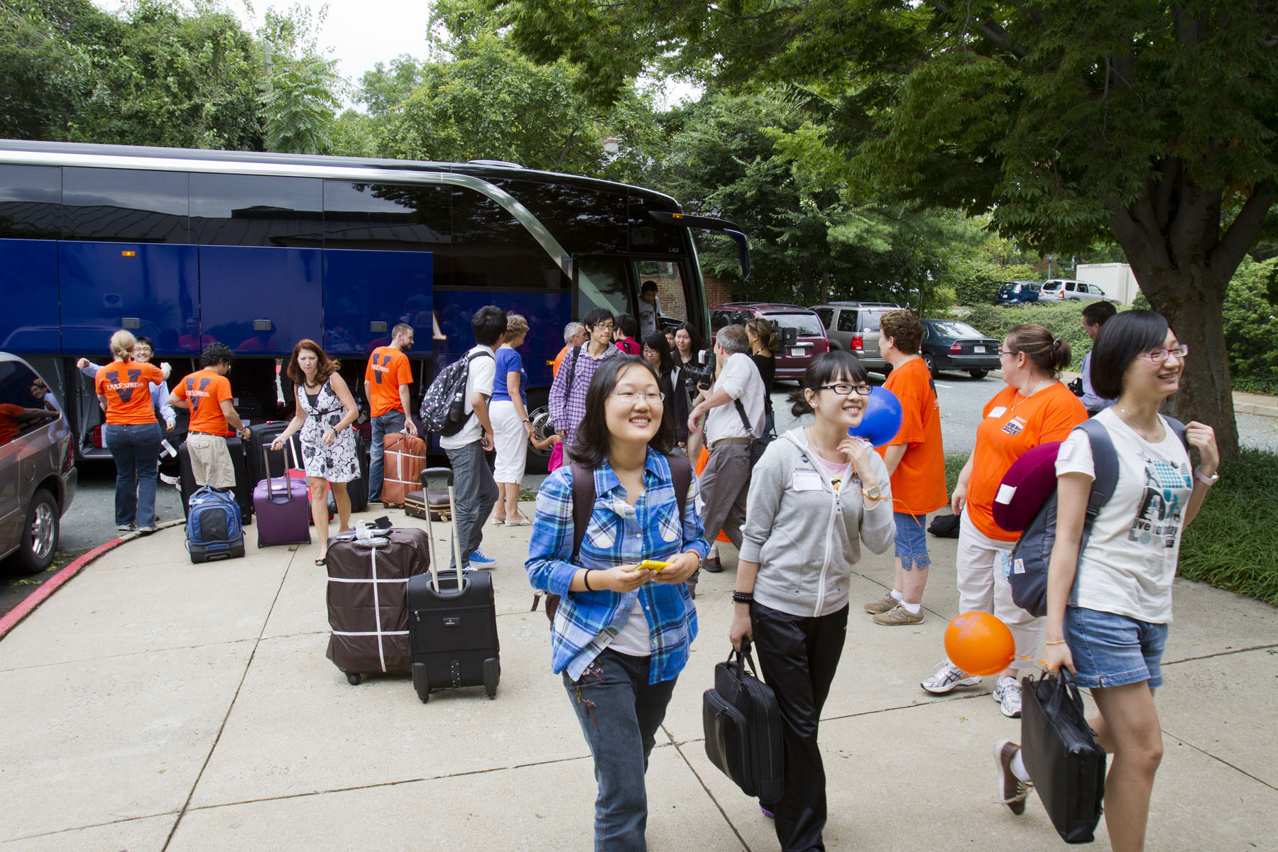 International Students getting off the UVA Express Transport bus with their personal belongings