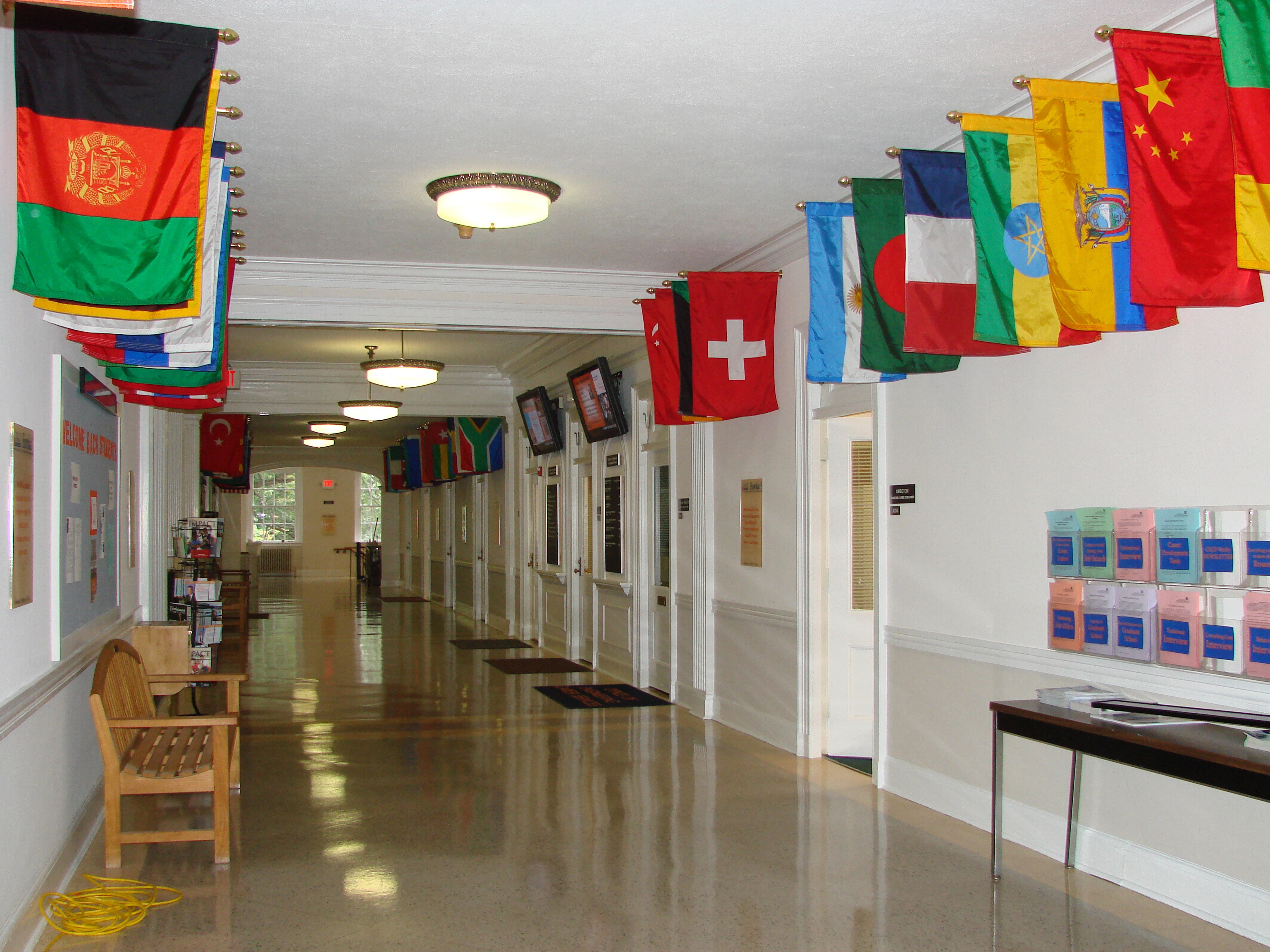 Various country Flags hanging at the top of the hallway outside of classrooms