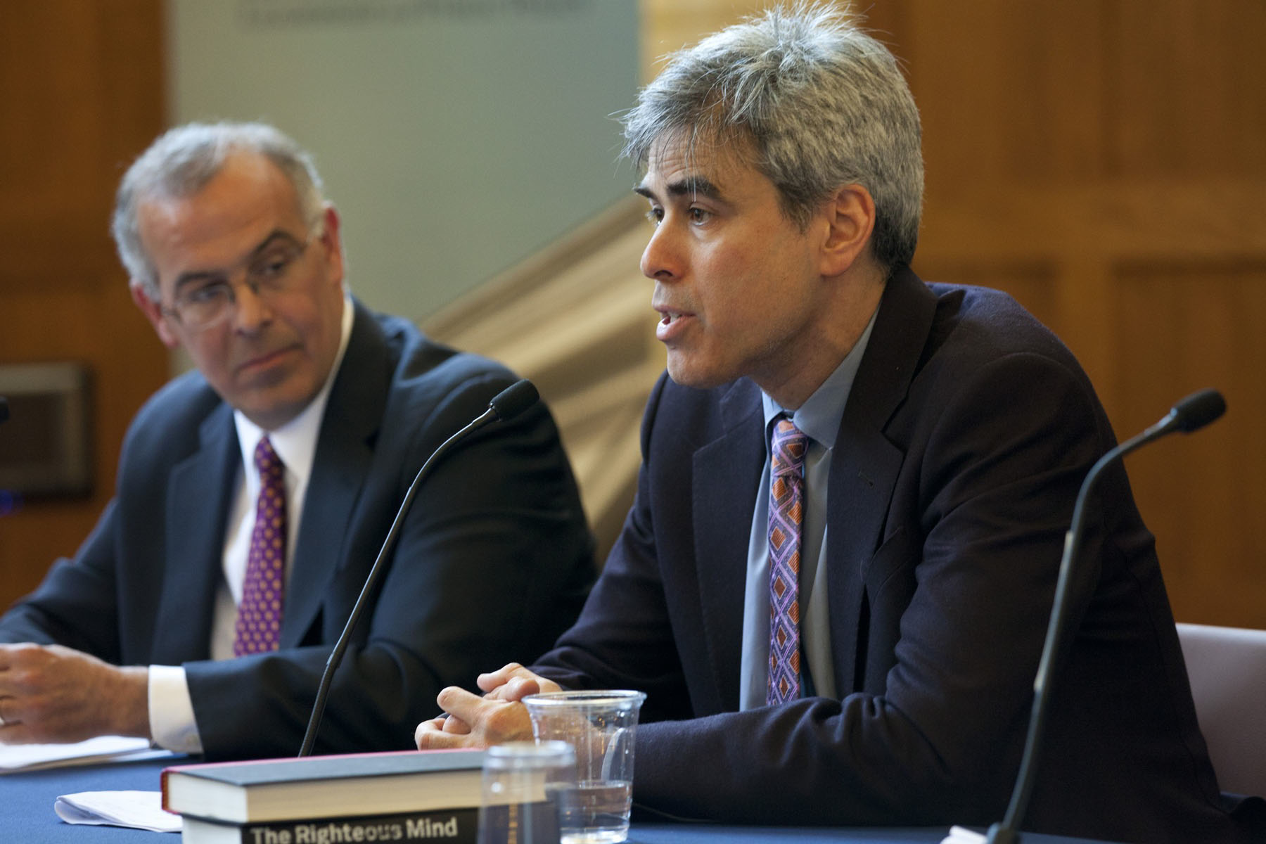 David Brooks and Jonathan Haidt talk to a crowd during a panel discussion