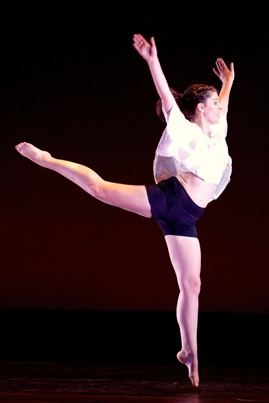 Woman Dancer with her arms raised and on leg behind her with her toe pointed