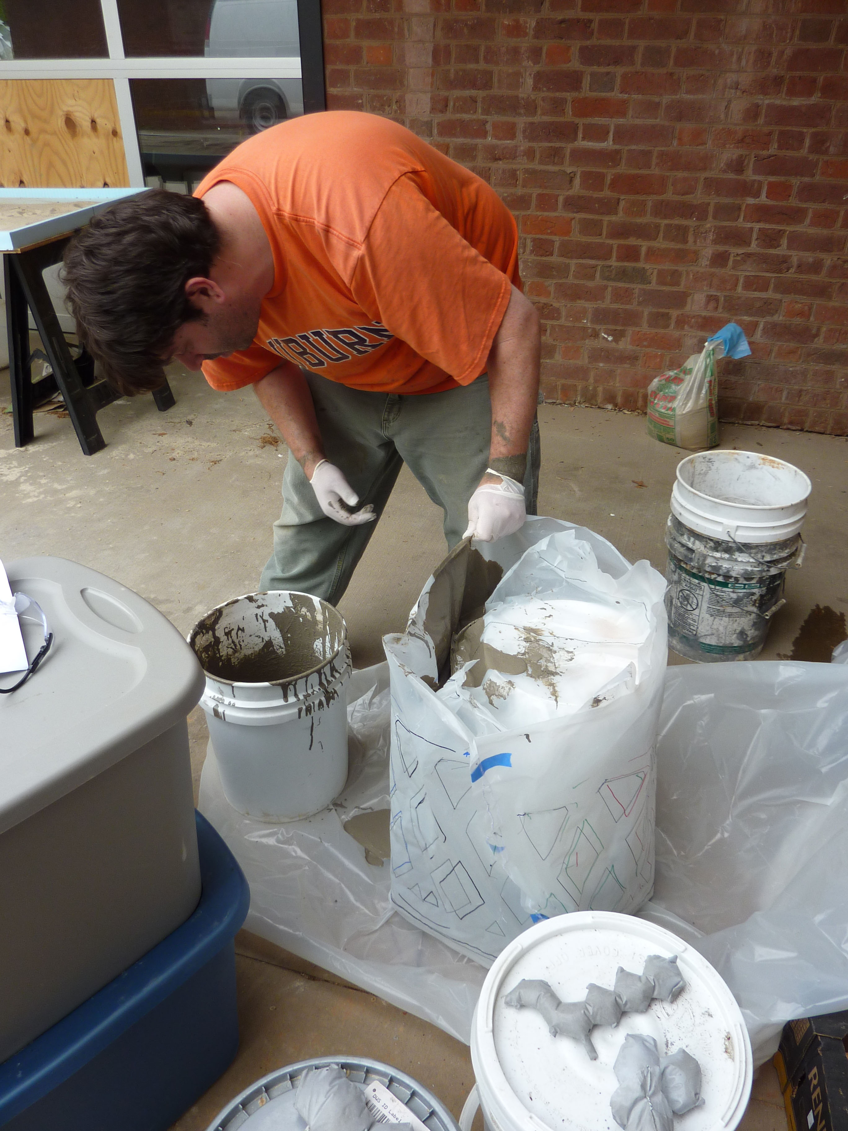 Nick Wickersham mixing and pouring concrete into molds