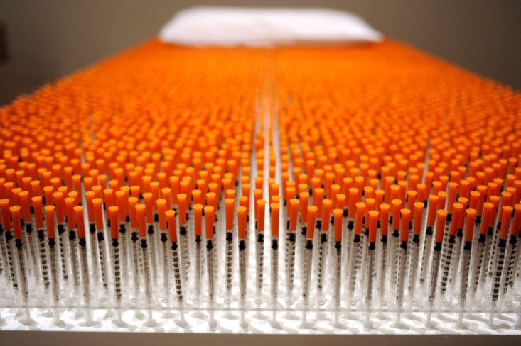 Tubes with orange caps lined in a tray
