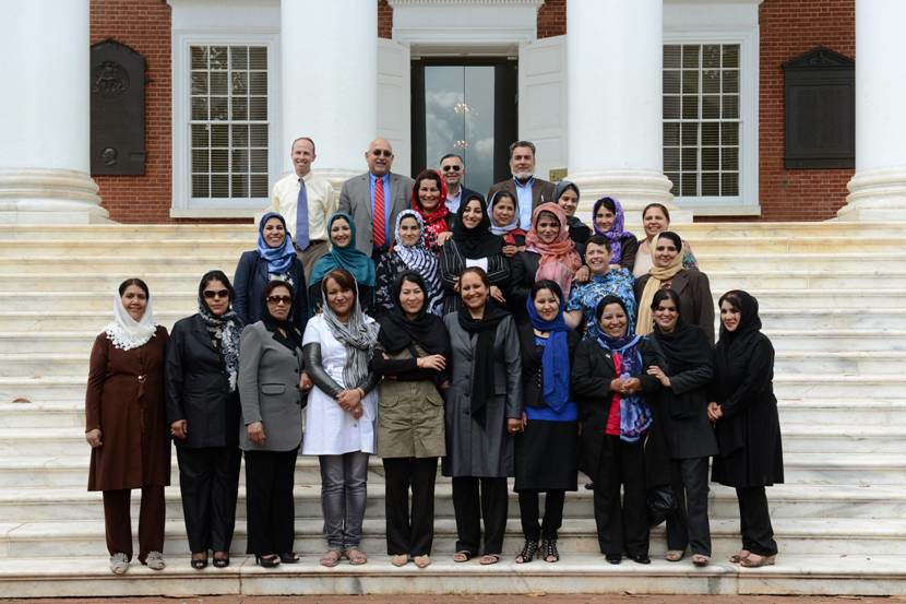 Group photo of the Afghan delegation standing on the steps of a brick building