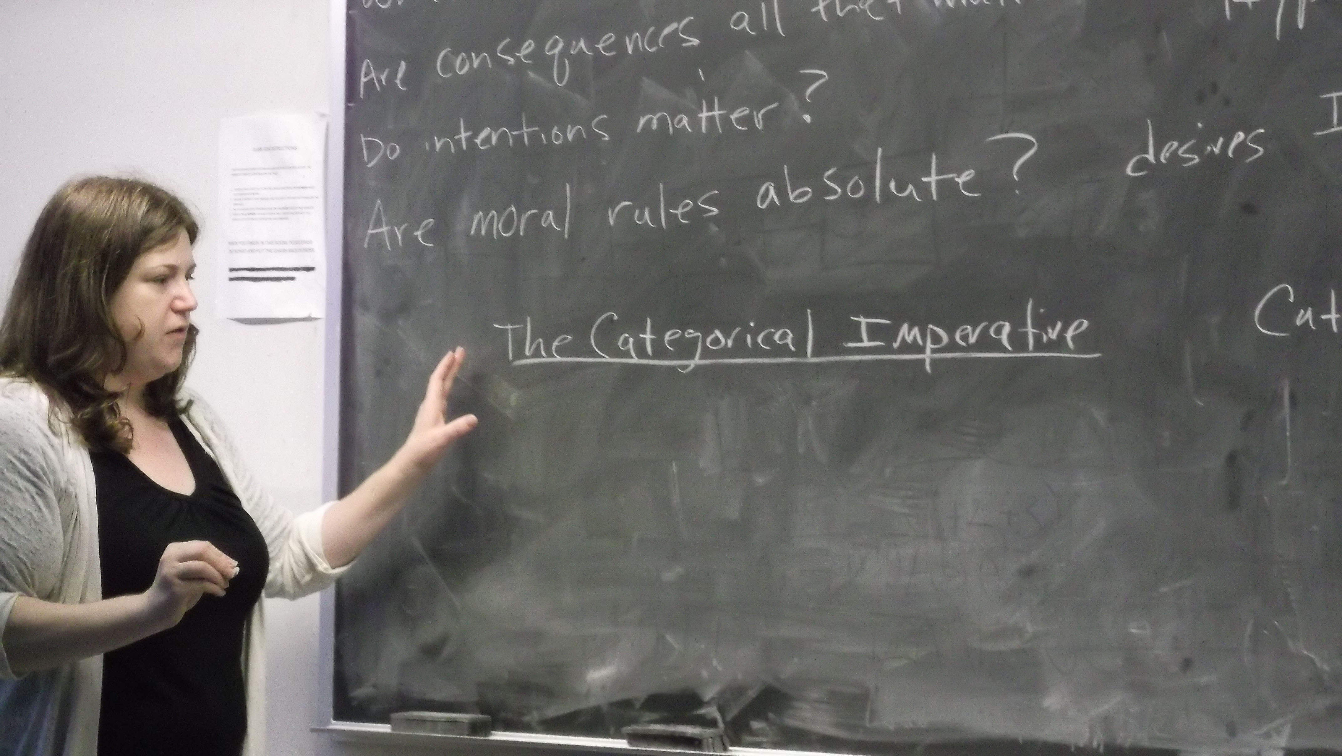 Stacie Thyrion teaching a class at a chalk board