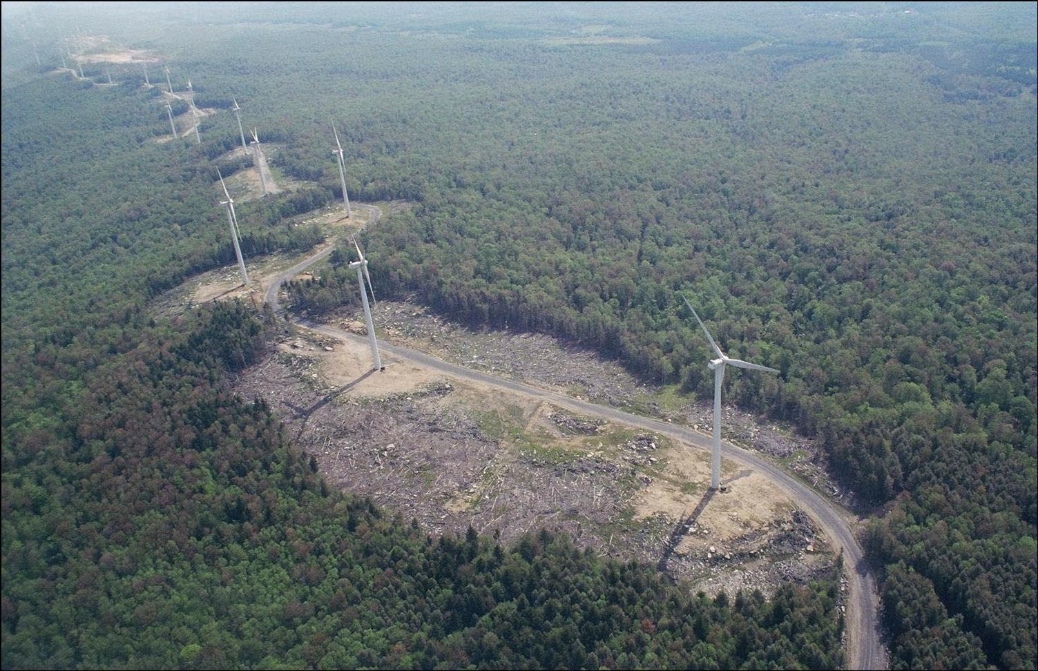 An aerial view of the 44-turbine Mountaineer wind energy project with the cleared out trees around each Turbine