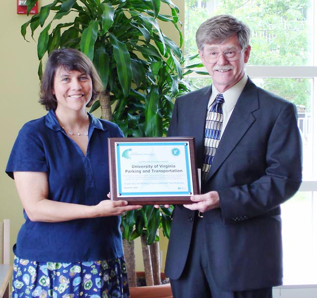 Larry Simmons, right and Rebecca White hold an award honoring UVA parking and transportation