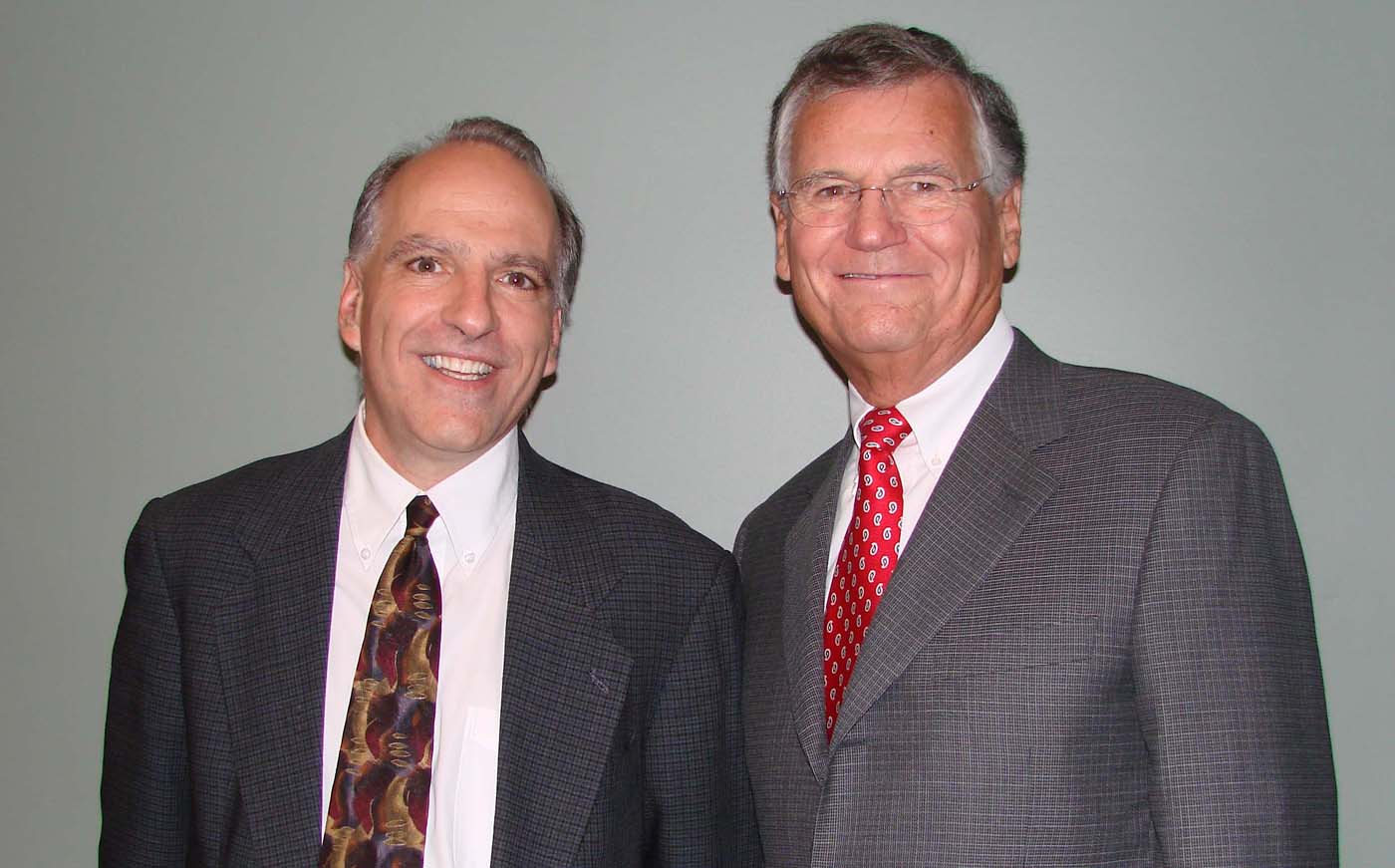 Matt Neurock stands with another man smiling at the camera