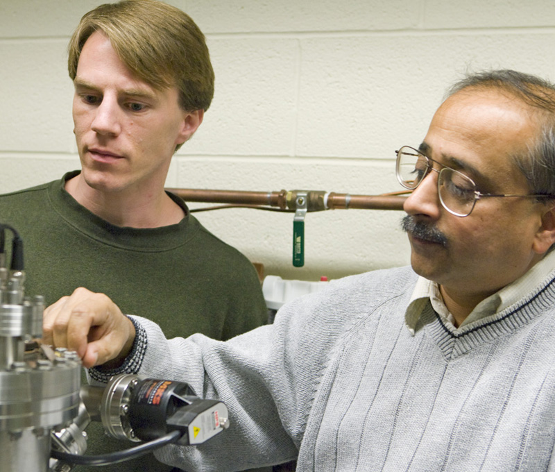 Adam Phillips, left, and Bellave S. Shivaram, right work in a lab together