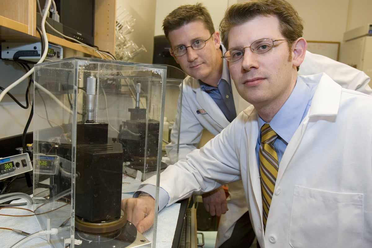 Brian Wamhoff, left, and Brett Blackman, right, work in a lab together