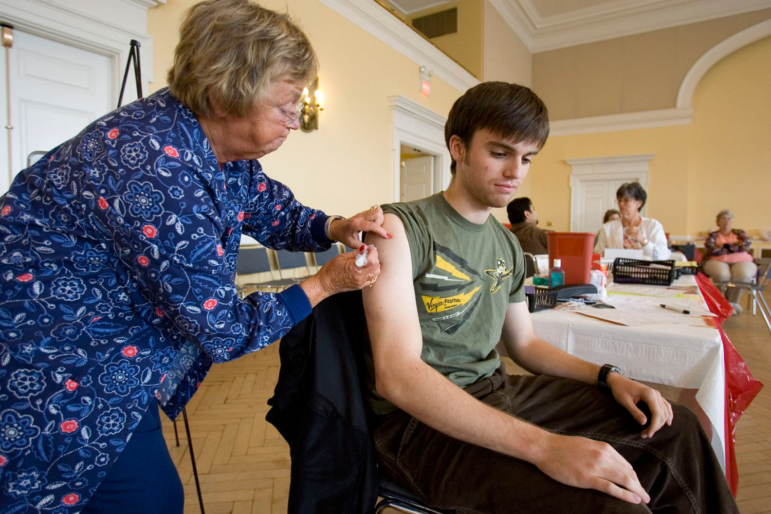 Patrick Neyland receives a flu shot from a Nurse
