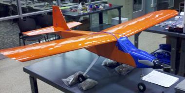 Small Blue and orange plane sitting on a lab table