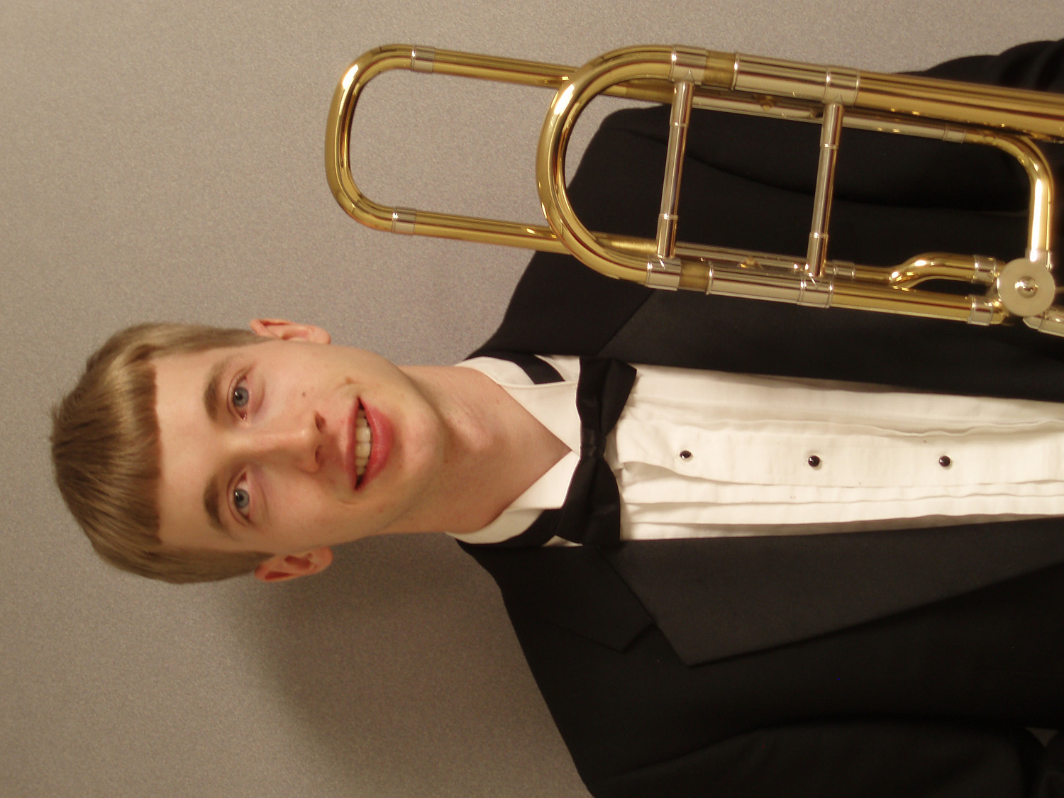 Darin J. Showalter headshot holding a trombone