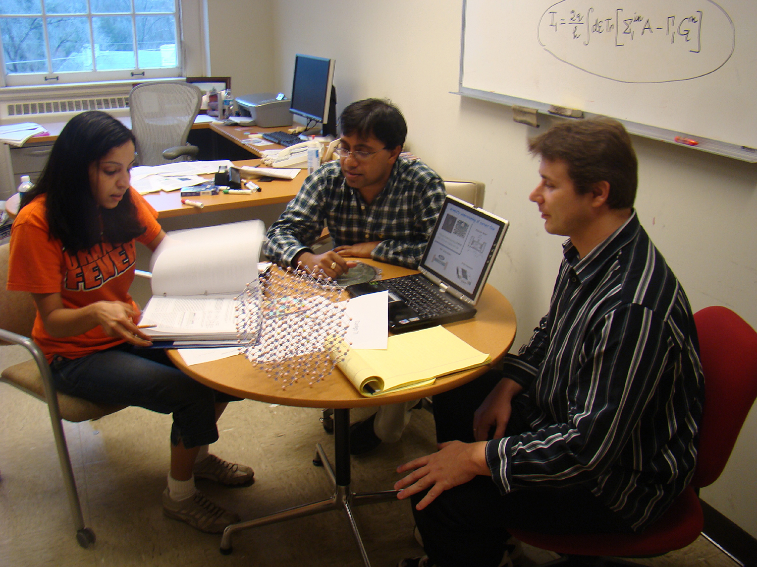 Smitha Vasudevan, Ghosh, and Dr Kamil Walczak all sit at a table working together